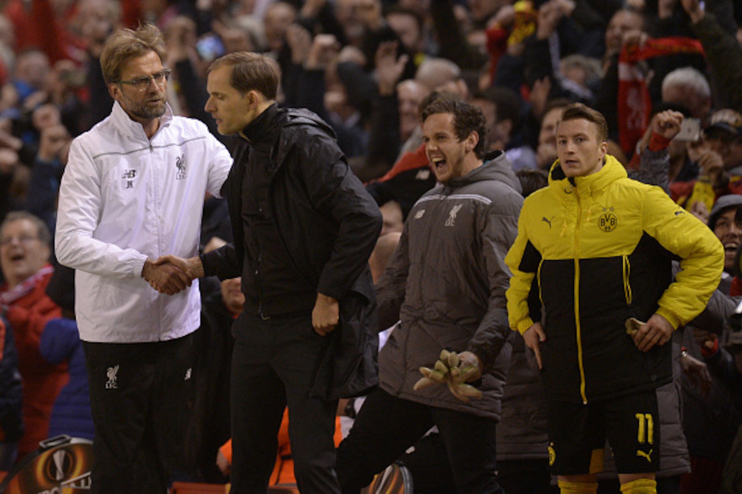 Liverpool's German manager Jurgen Klopp (L) shakes hands with Dortmund's head coach Thomas Tuchel after winning the UEFA Europa league quarter-final second leg football match between Liverpool  and Borussia Dortmund at Anfield stadium in Liverpool on Apri