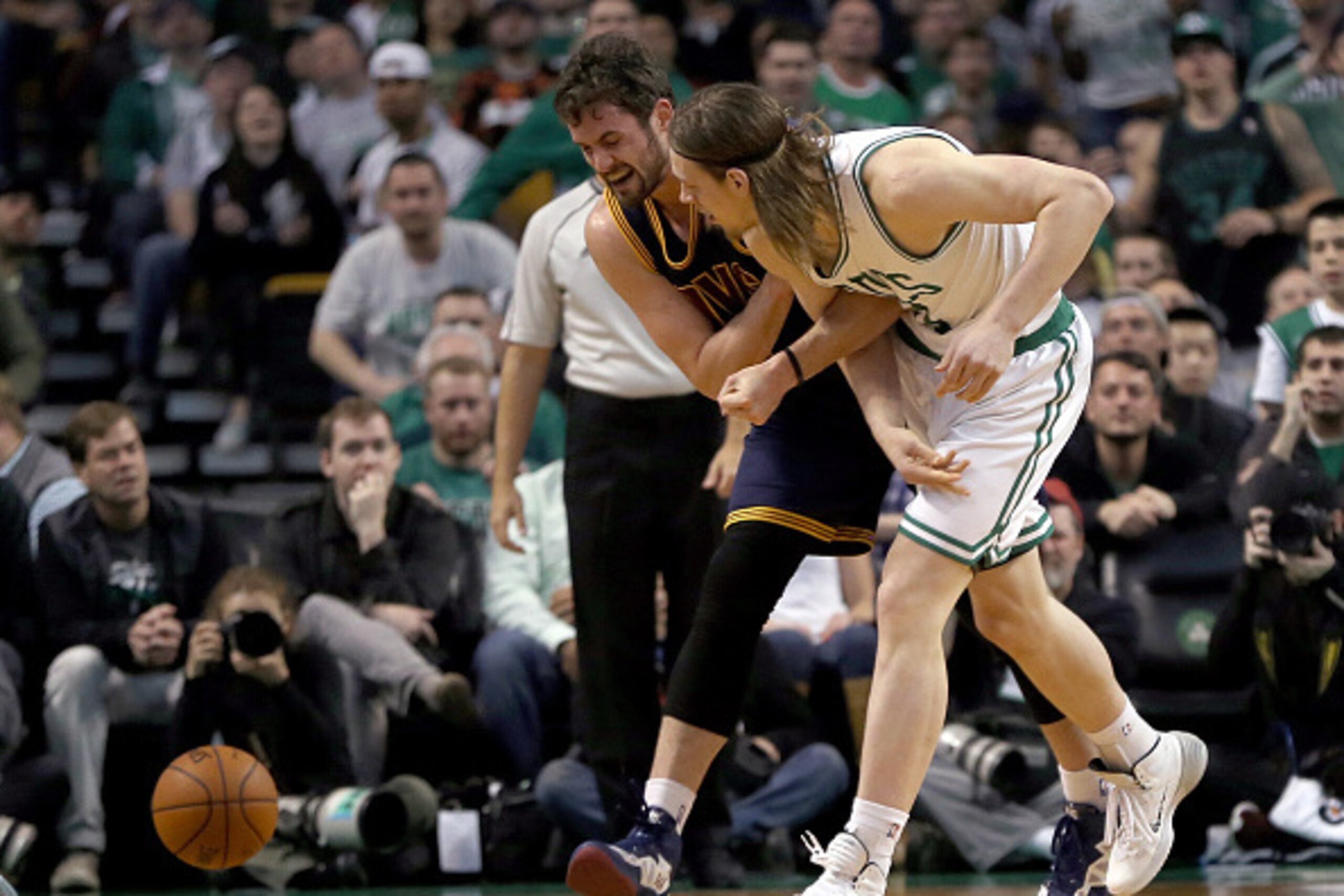BOSTON, MA - APRIL 26: Kevin Love #0 of the Cleveland Cavaliers injures his shoulder as he chases a loose ball against Kelly Olynyk #41 of the Boston Celtics in the first half in Game Four during the first round of the 2015 NBA Playoffs on April 26, 2015 