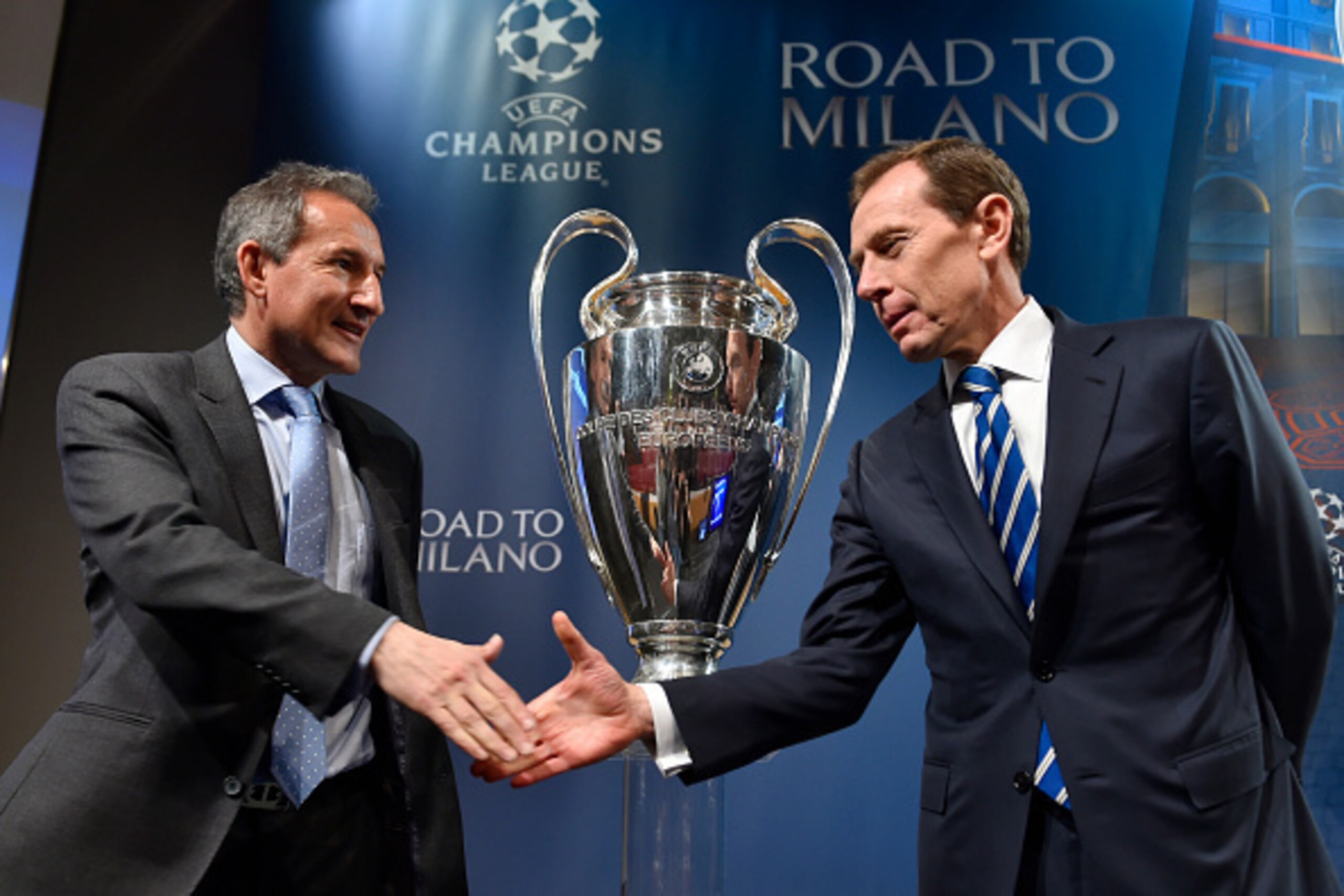 Real Madrid director of institutional relations Emilio Butragueno (R) shakes hands with Manchester City football director Txiki Begiristain after the semi-final draw for the UEFA Champions League at the UEFA headquarters in Nyon on April 15, 2016.   AFP P
