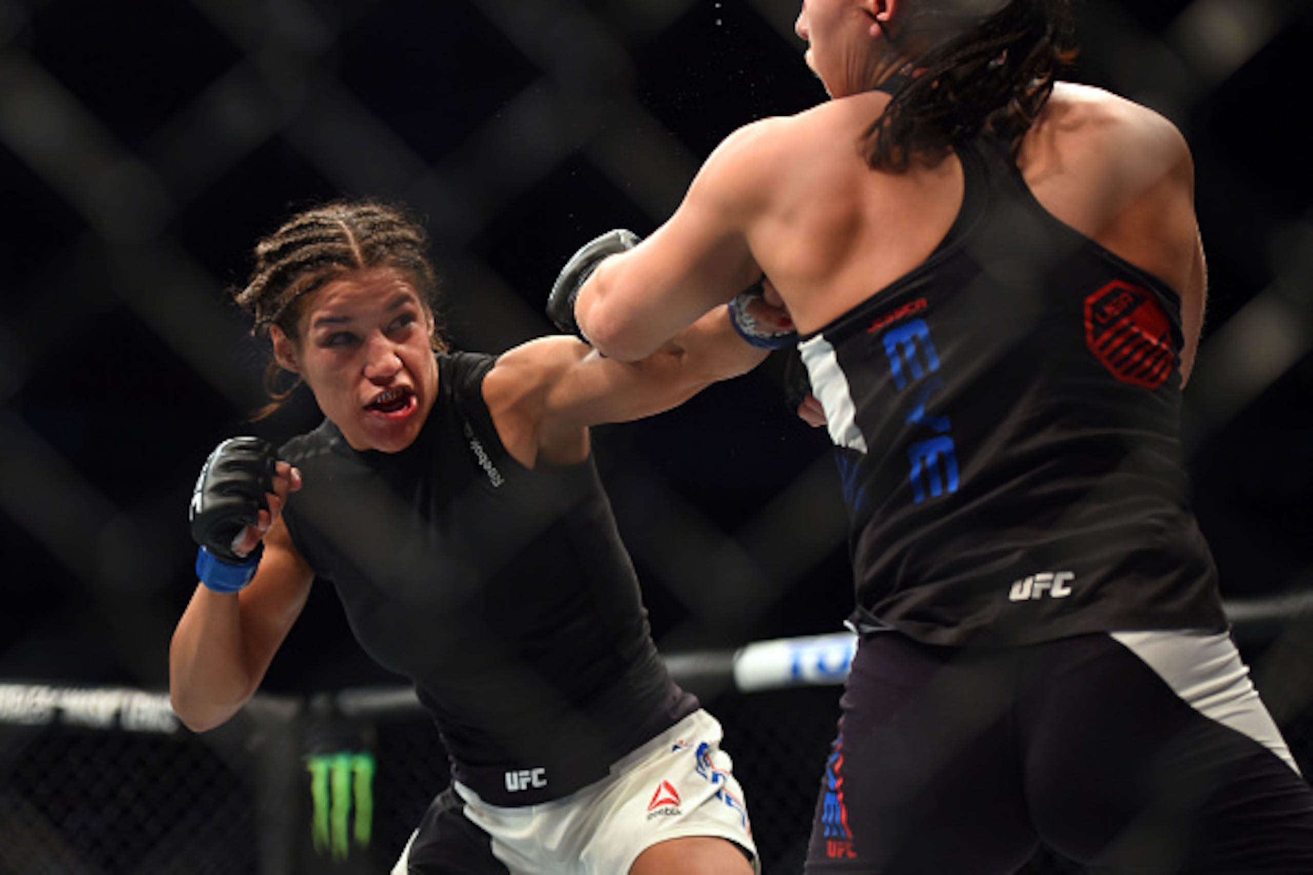 HOUSTON, TX - OCTOBER 03:  (L-R) Julianna Pena punches Jessica Eye in their women's bantamweight bout during the UFC 192 event at the Toyota Center on October 3, 2015 in Houston, Texas. (Photo by Jeff Bottari/Zuffa LLC/Zuffa LLC via Getty Images)