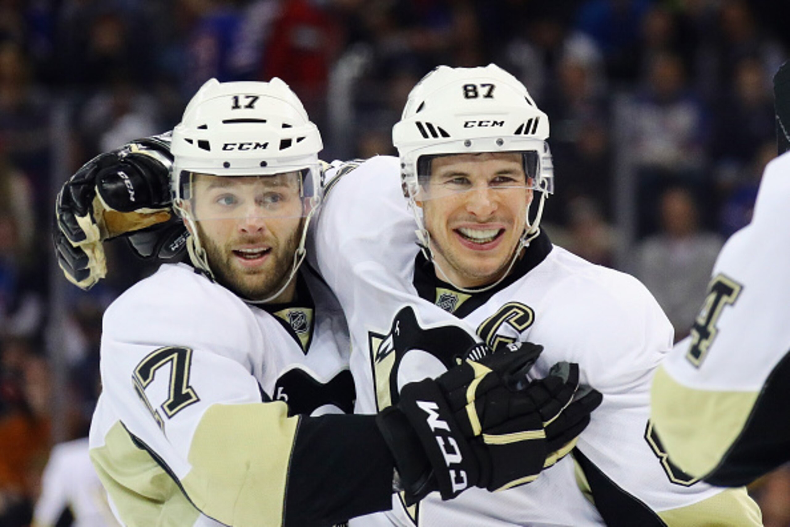 NEW YORK, NY - MARCH 13:  Sidney Crosby #87 of the Pittsburgh Penguins (r) celebrates his empty net goal at 19:21 of the third period against the New York Rangers and is joined by Bryan Rust #17 at Madison Square Garden on March 13, 2016 in New York City.