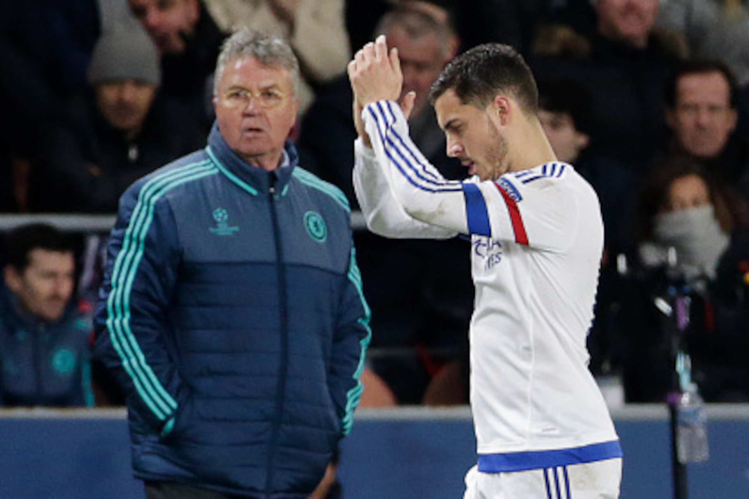 Chelsea's Belgian midfielder Eden Hazard (R) applauds as he passes Chelsea's Dutch coach Guus Hiddink  during the Champions League round of 16 first leg football match between Paris Saint-Germain (PSG) and Chelsea FC on February 16, 2016, at the Parc des 