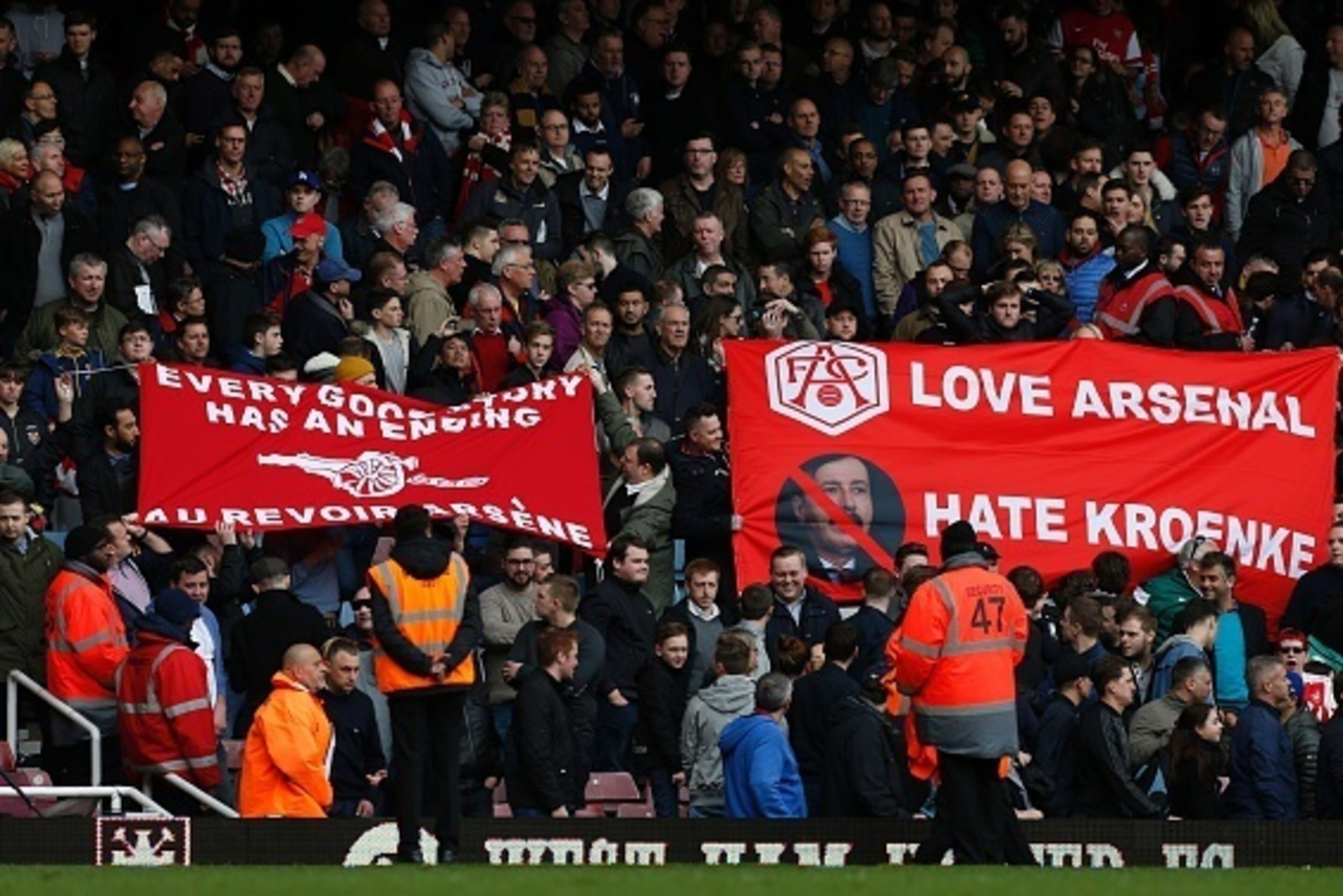 Arsenal fans hold banners calling for Arsenal's French manager Arsene Wenger to leave, and showing their dislike of Arsenal's US Owner Stan Kroenke, following the English Premier League football match between West Ham United and Arsenal at The Boleyn Grou