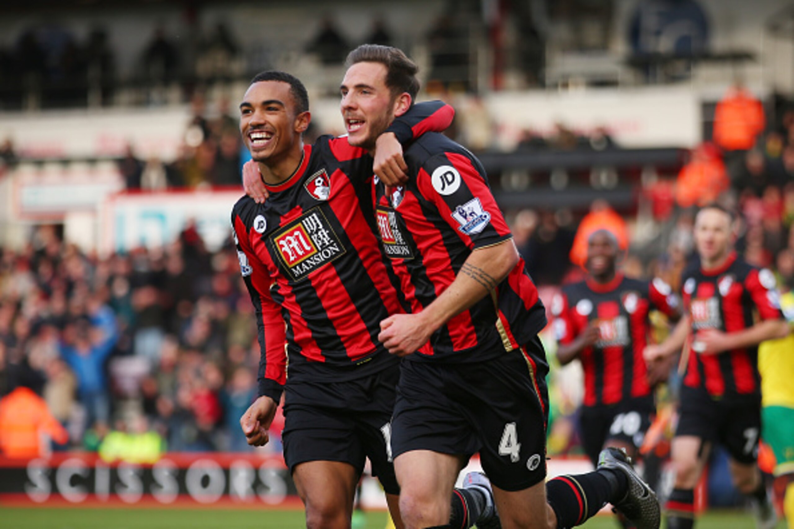 BOURNEMOUTH, ENGLAND - JANUARY 16:  Dan Gosling (R) of Bournemouth celebrates scoring his team's first goal with his team mate Junior Stanislas (L)during the Barclays Premier League match between A.F.C. Bournemouth and Norwich City at the Vitality Stadium