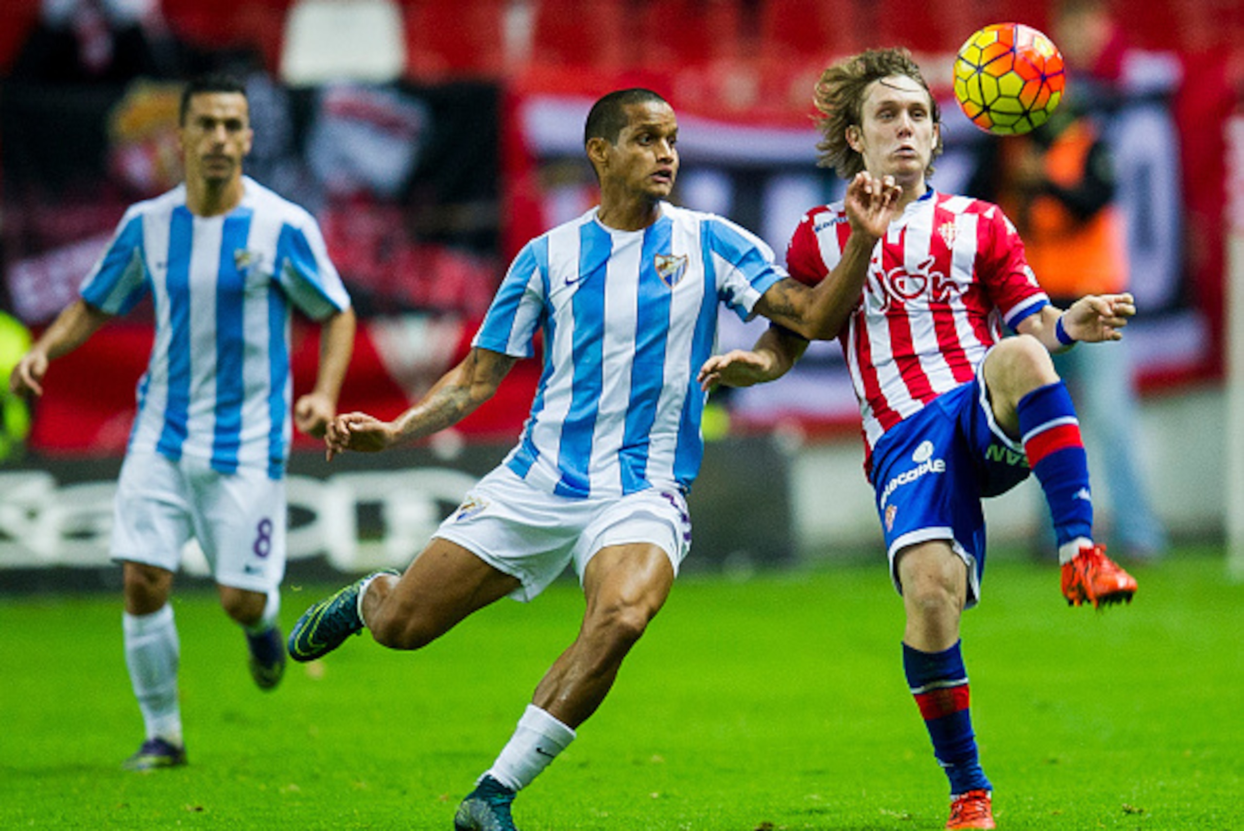 GIJON, SPAIN - NOVEMBER 01: Halilovic of Real Sporting de Gijon duels for the ball with Roberto Rosales of Malaga CF during the La Liga match between Real Sporting de Gijon and Malaga CF at Estadio El Molinon on November 1, 2015 in Gijon, Spain. (Photo GIJON, SPAIN - NOVEMBER 01: Halilovic of Real Sporting de Gijon duels for the ball with Roberto Rosales of Malaga CF during the La Liga match between Real Sporting de Gijon and Malaga CF at Estadio El Molinon on November 1, 2015 in Gijon, Spain. (Photo