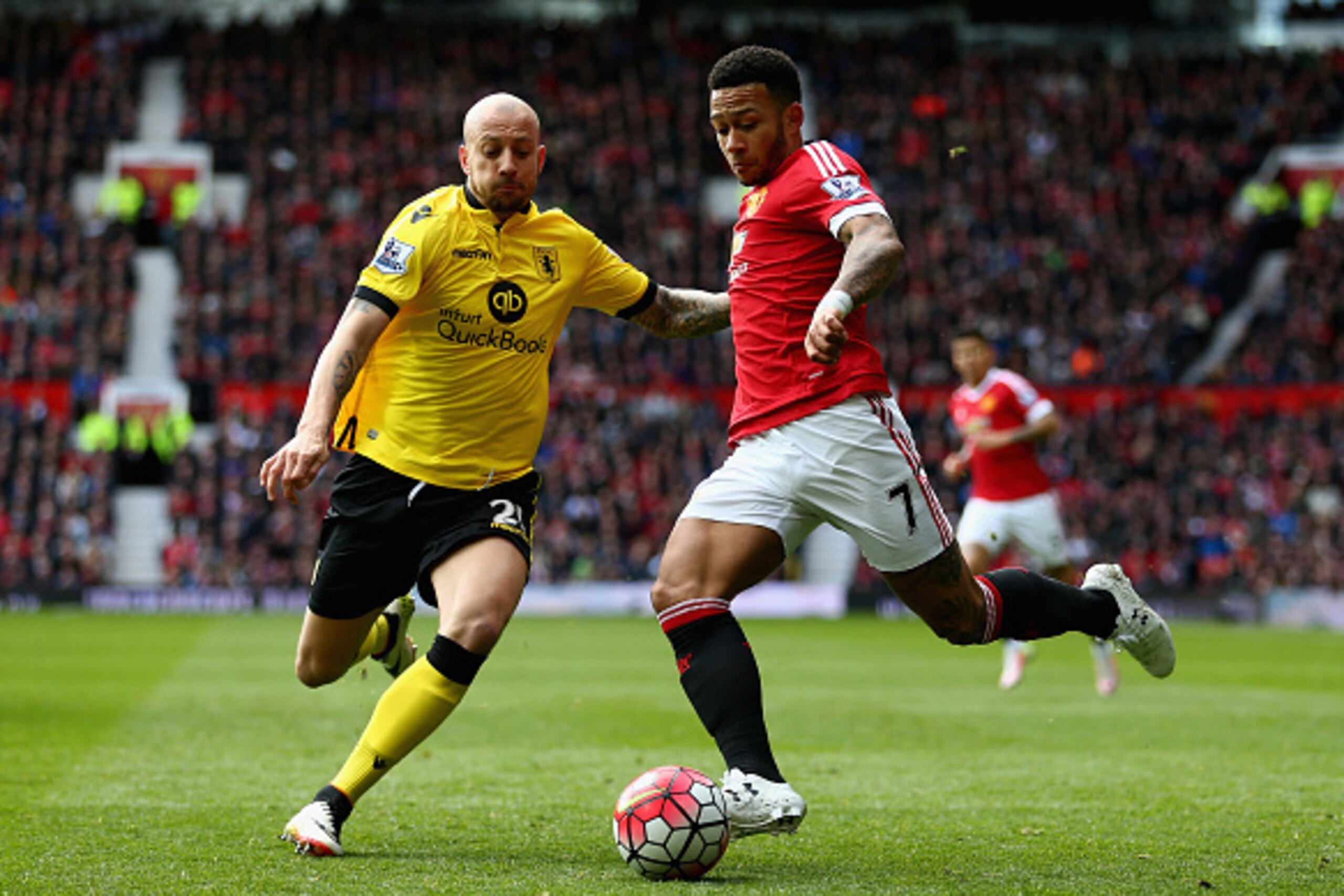 MANCHESTER, ENGLAND - APRIL 16:  Memphis Depay of Manchester United is challenged by Alan Hutton of Aston Villa during the Barclays Premier League match between Manchester United and Aston Villa at Old Trafford on April 16, 2016 in Manchester, England.  (