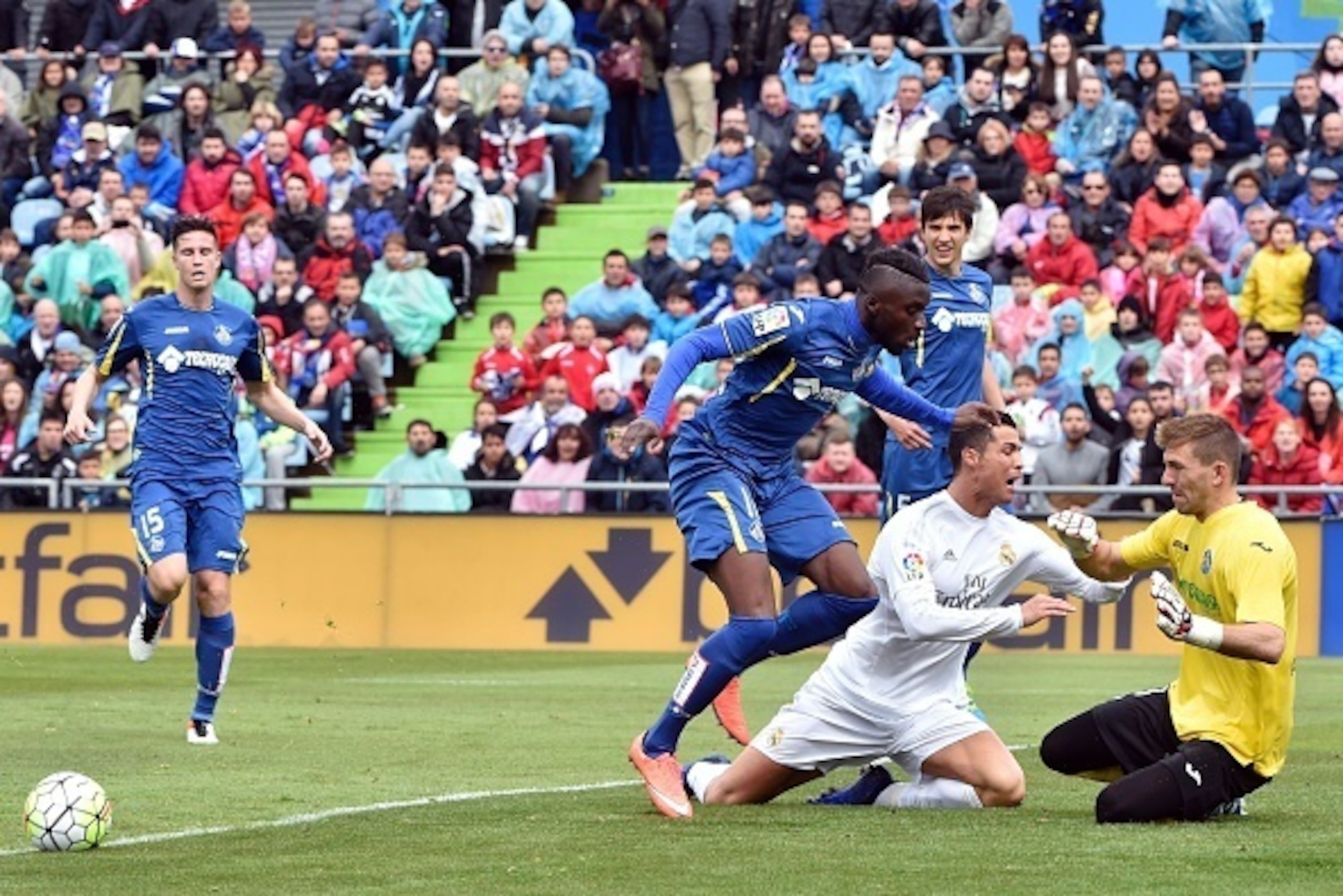 Real Madrid's Portuguese forward Cristiano Ronaldo (2nd R) kneels on the field after missing a goal opportunity next to Getafe's Burkinabe midfielder Karim Abdoul Yoda (2nd L) and Getafe's goalkeeper Vicente Guaita (R) during the Spanish league football m