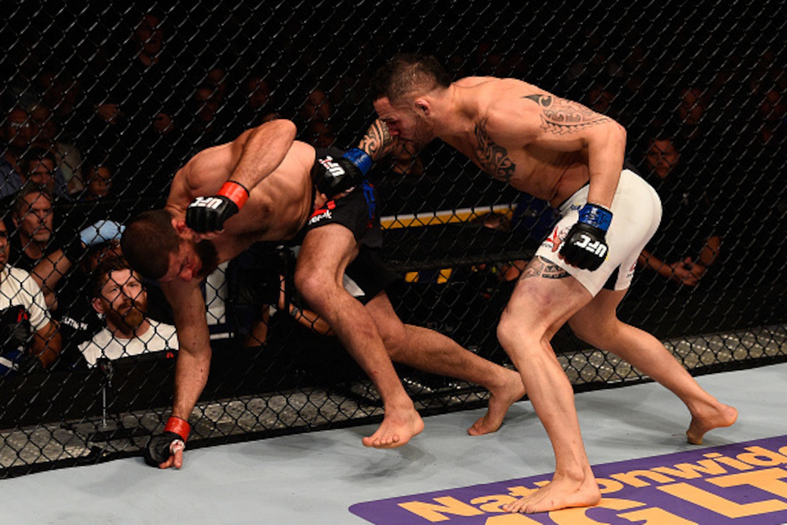 TAMPA, FL - APRIL 16:   (R-L) Santiago Ponzinibbio punches Court McGee in their welterweight bout during the UFC Fight Night event at Amalie Arena on April 16, 2016 in Tampa, Florida. (Photo by Jeff Bottari/Zuffa LLC/Zuffa LLC via Getty Images)