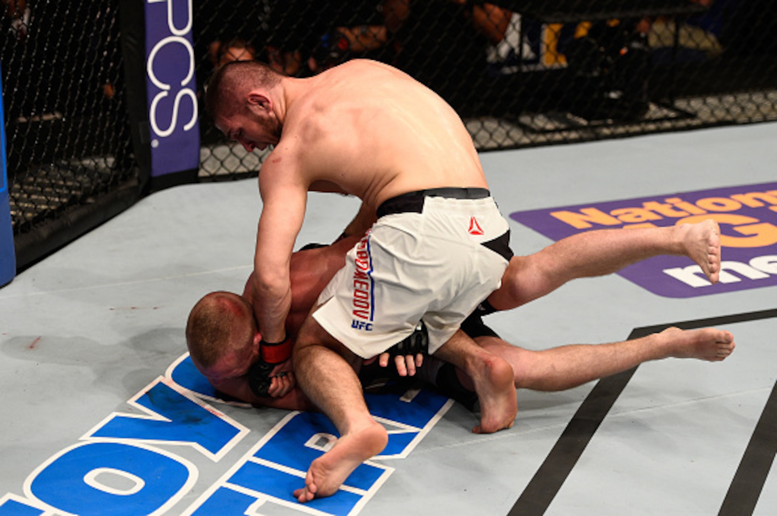 TAMPA, FL - APRIL 16:   Khabib Nurmagomedov (top) punches Darrell Horcher in their lightweight bout during the UFC Fight Night event at Amalie Arena on April 16, 2016 in Tampa, Florida. (Photo by Jeff Bottari/Zuffa LLC/Zuffa LLC via Getty Images)