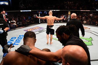 TAMPA, FL - APRIL 16:   (R-L) Glover Teixeira celebrates his knockout victory over Rashad Evans in their light heavyweight bout during the UFC Fight Night event at Amalie Arena on April 16, 2016 in Tampa, Florida. (Photo by Jeff Bottari/Zuffa LLC/Zuffa LL