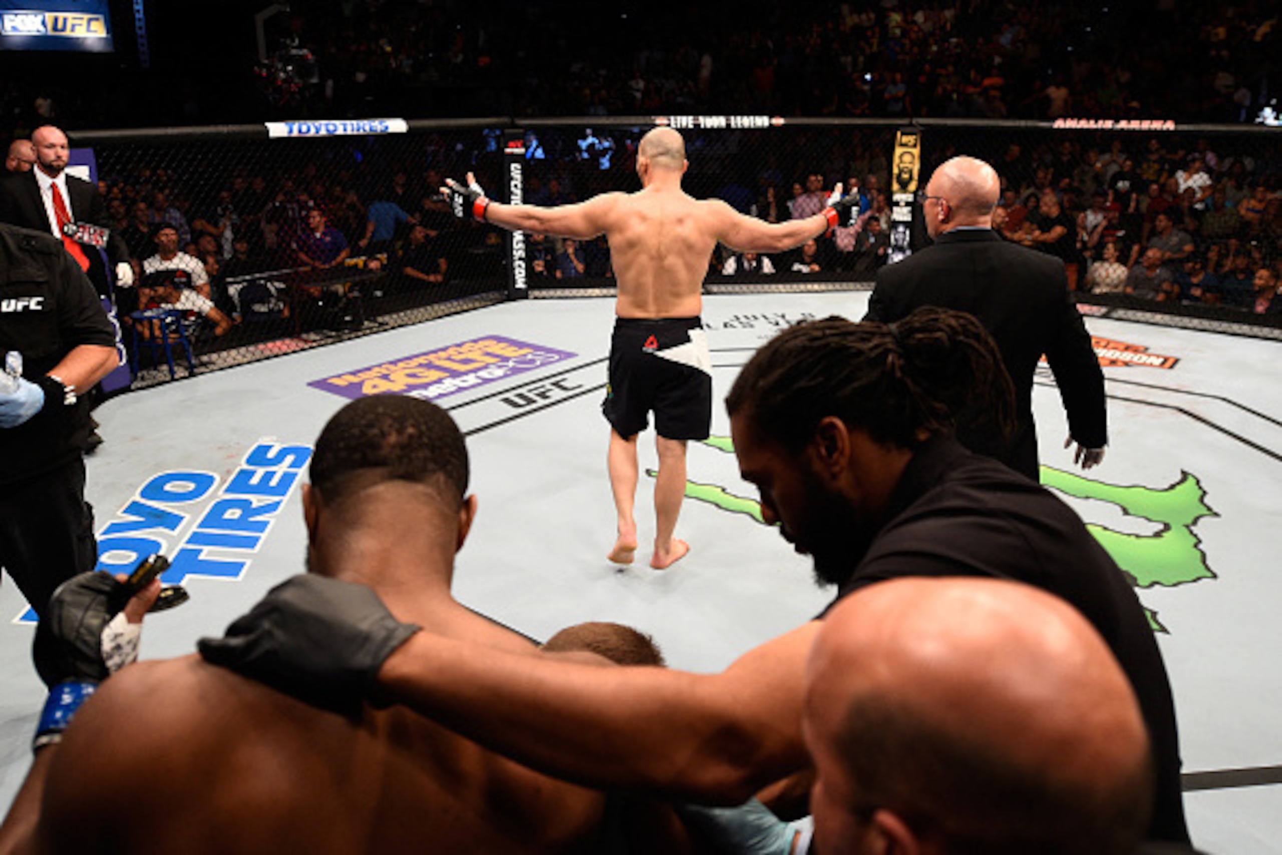 TAMPA, FL - APRIL 16:   (R-L) Glover Teixeira celebrates his knockout victory over Rashad Evans in their light heavyweight bout during the UFC Fight Night event at Amalie Arena on April 16, 2016 in Tampa, Florida. (Photo by Jeff Bottari/Zuffa LLC/Zuffa LL