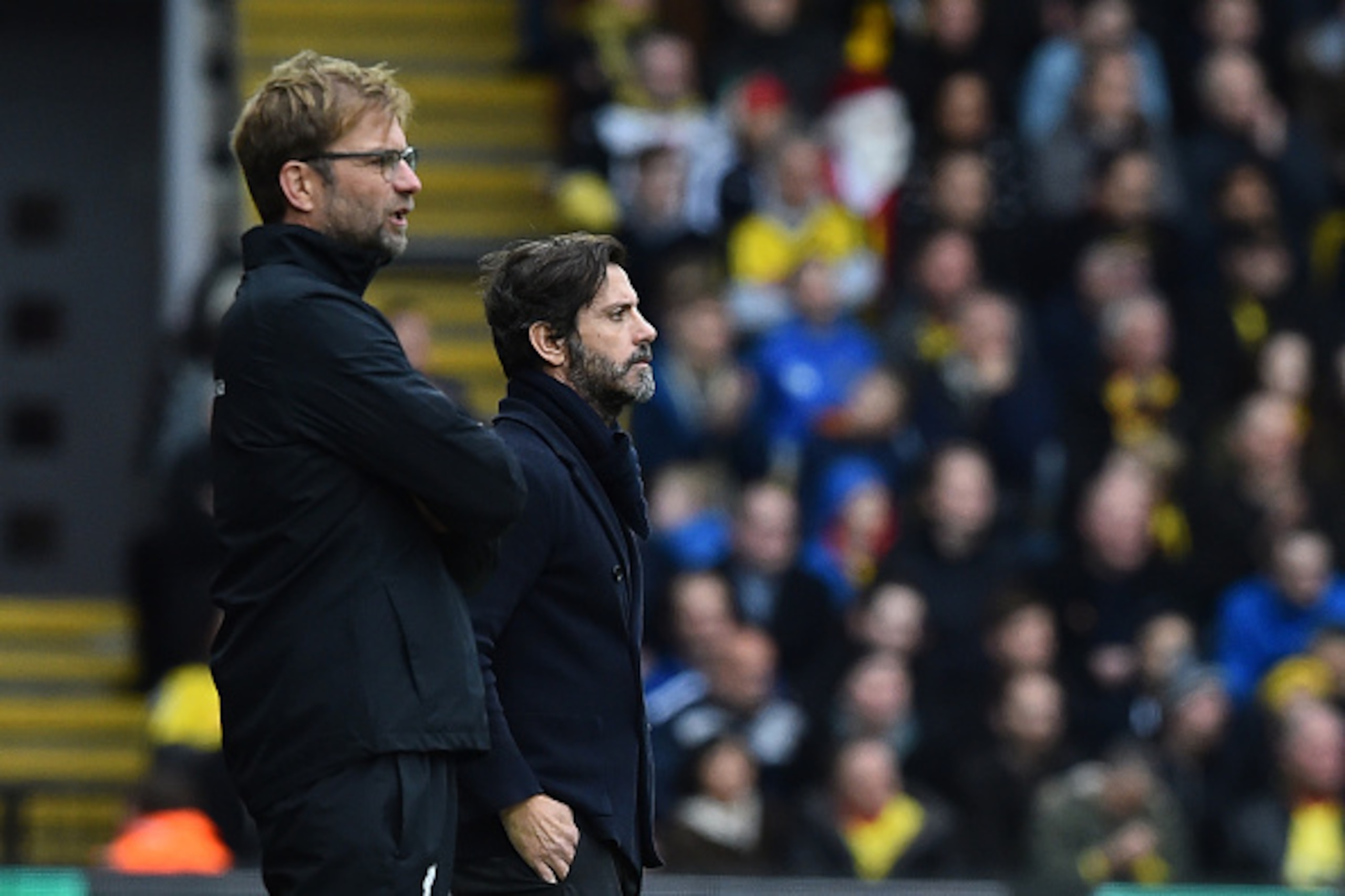 Watford's Spanish manager Quique Sanchez Flores (R) and Liverpool's German manager Jurgen Klopp (L) watch from the touchline during the English Premier League football match between Watford and Liverpool at Vicarage Road Stadium in Watford, north of Londo