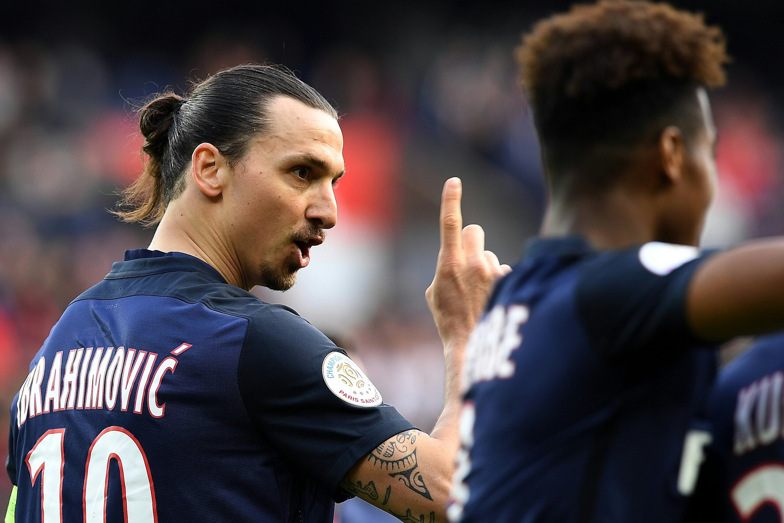 Paris Saint-Germain's Swedish forward Zlatan Ibrahimovic (L) reacts during the French L1 football match between Paris Saint-Germain and Caen at the Parc des Princes stadium in Paris on April 16, 2016.  / AFP / FRANCK FIFE        (Photo credit should read