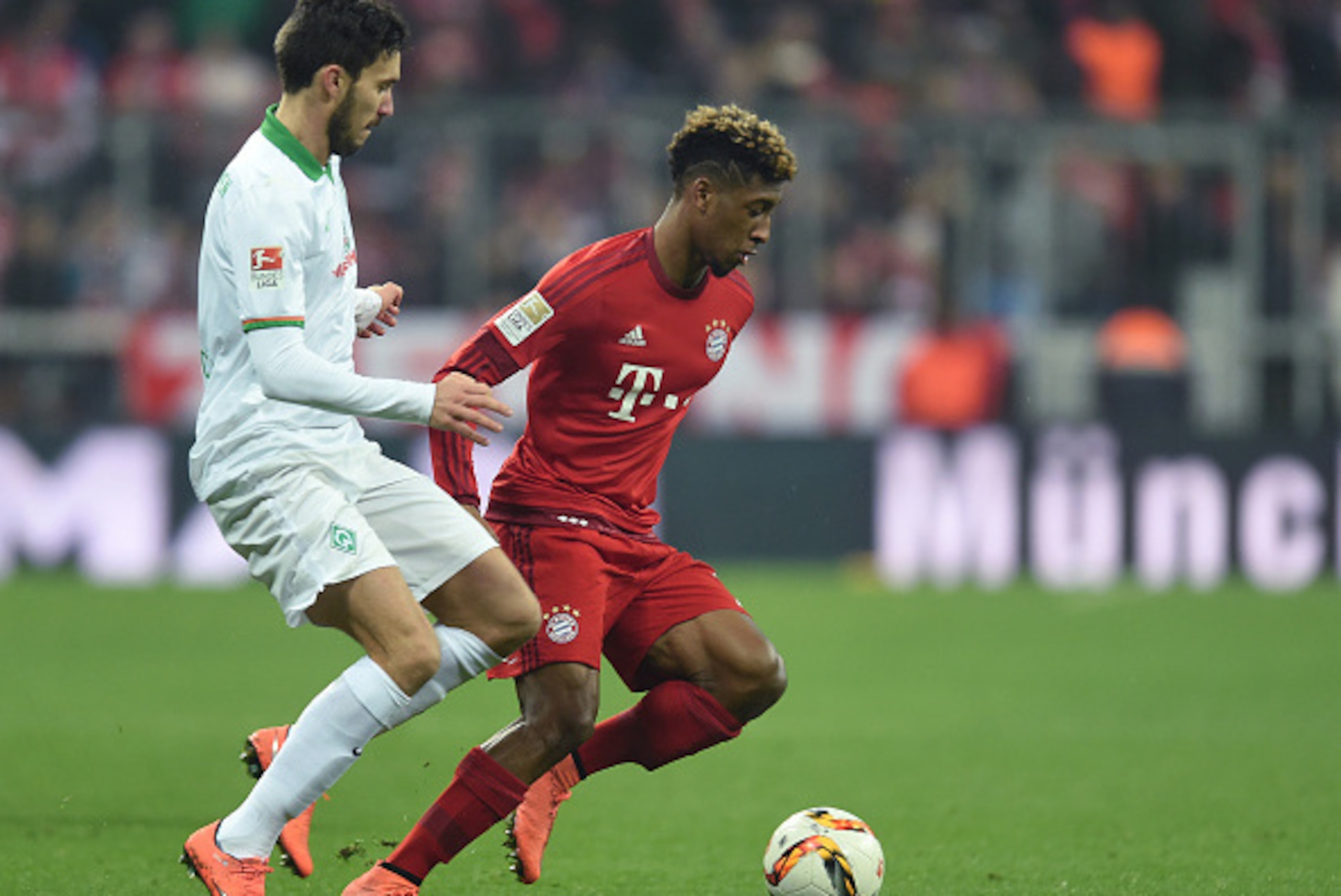 Bayern Munich's French midfielder Kingsley Coman (R) and Bremen's Argentinian defender Santiago Garcia (L) vie for the ball during the German first division Bundesliga football match FC Bayern Munich v Werder Bremen in Munich, southern Germany on March 12