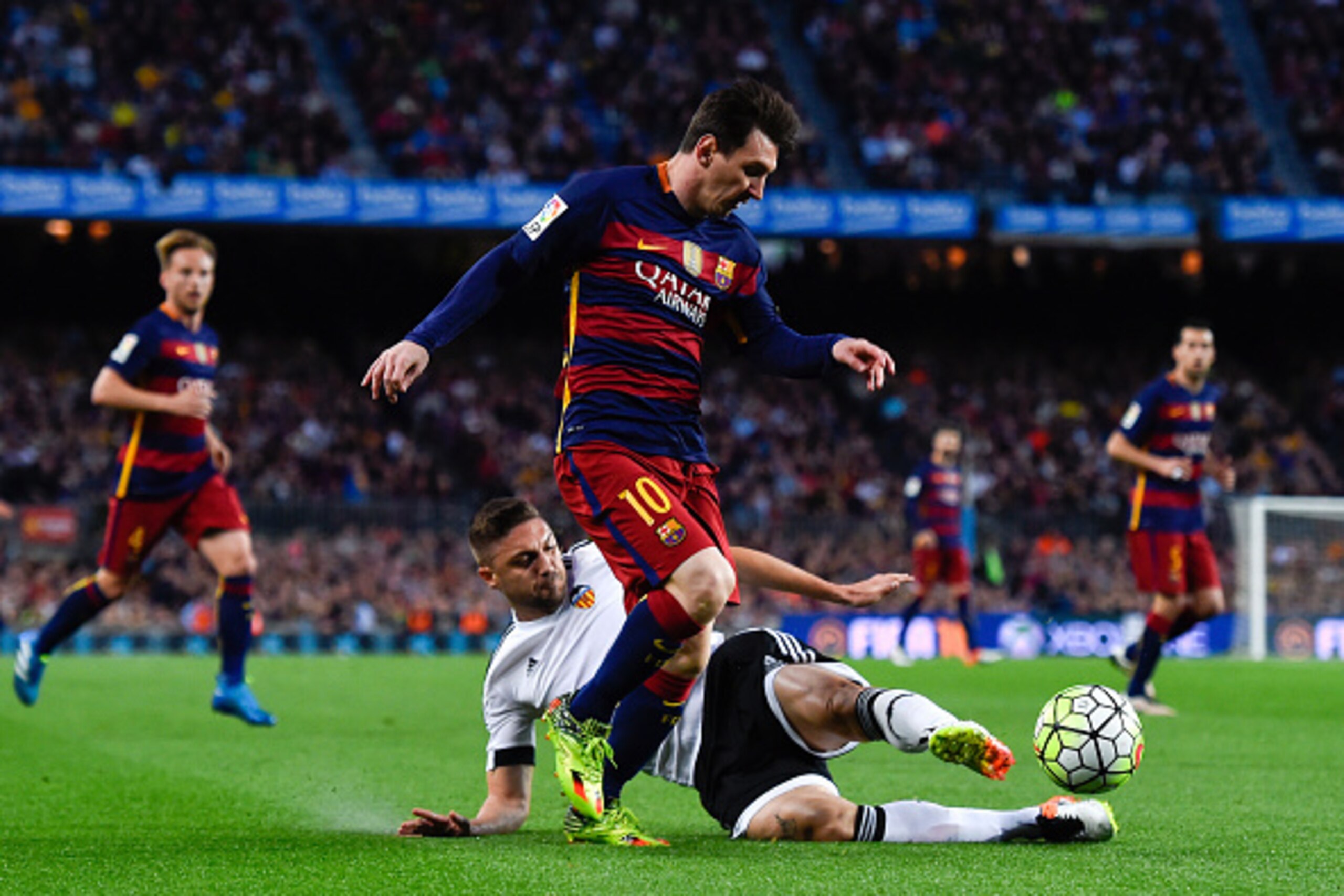 BARCELONA, SPAIN - APRIL 17:  Lionel Messi of FC Barcelona competes for the ball with Guilherme Siqueira of Valencia CF during the La Liga match between FC Barcelona and Valencia CF at Camp Nou on April 17, 2016 in Barcelona, Spain.  (Photo by David Ramos