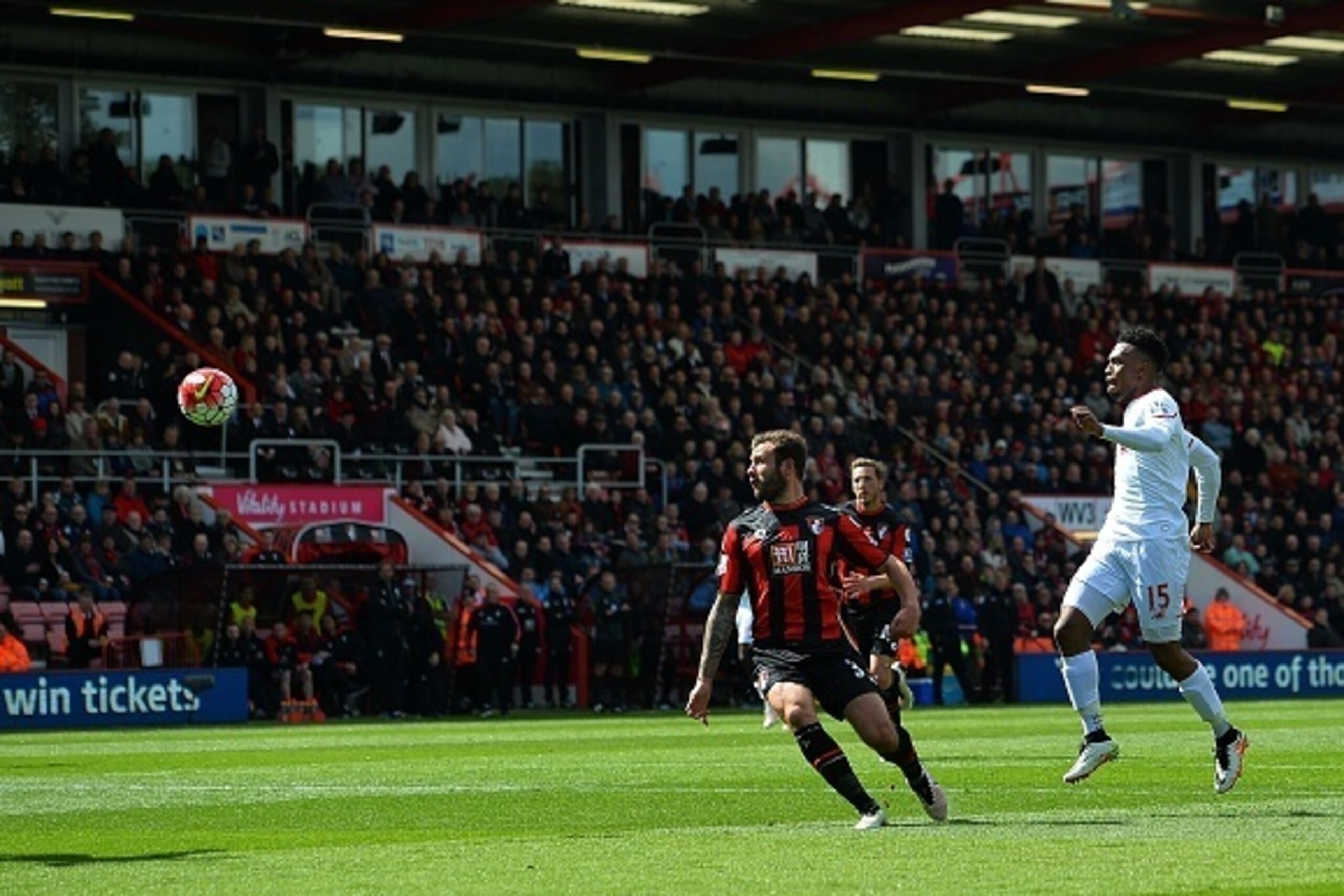 Liverpool's English striker Daniel Sturridge (R) watches the ball as his shot on goal goes wide during the English Premier League football match between Bournemouth and Liverpool at the Vitality Stadium in Bournemouth, southern England on April 17, 2016. 
