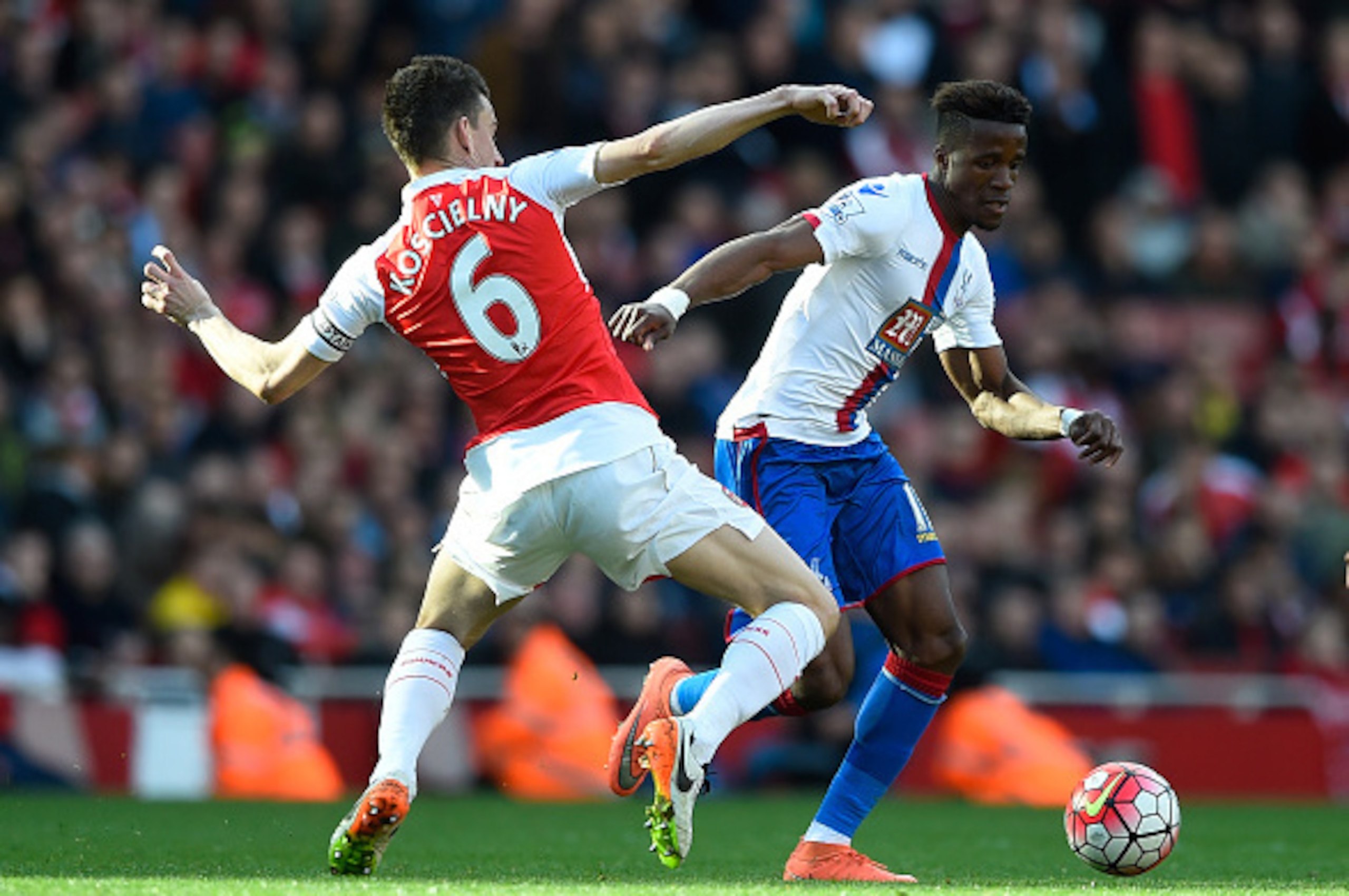 LONDON, ENGLAND - APRIL 17:  Wilfried Zaha of Crystal Palace takes on Laurent Koscielny of Arsenal during the Barclays Premier League match between Arsenal and Crystal Palace at the Emirates Stadium on April 17, 2016 in London, England.  (Photo by Mike He