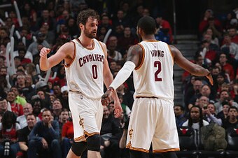 CHICAGO, IL - APRIL 9: Kevin Love #0 and Kyrie Irving #2 of the Cleveland Cavaliers celebrate against the Chicago Bulls  on April 9, 2016 at the United Center in Chicago, Illinois. NOTE TO USER: User expressly acknowledges and agrees that, by downloading 
