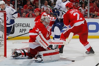 DETROIT, MI - APRIL 17: Petr Mrazek #34 of the Detroit Red Wings makes a third period save next to teammate Brendan Smith #2 while playing the Tampa Bay Lightning  in Game Three of the Eastern Conference Quarterfinals during the 2016 NHL Stanley Cup Playo
