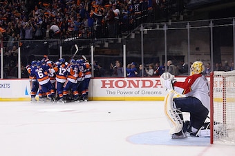 NEW YORK, NEW YORK - APRIL 17:  The New York Islanders celebrate the game winning overtime goal by Thomas Hickey #14 against Roberto Luongo #1 of the Florida Panthers during Game Three of the Eastern Conference Quarterfinals during the 2015 NHL Stanley Cu