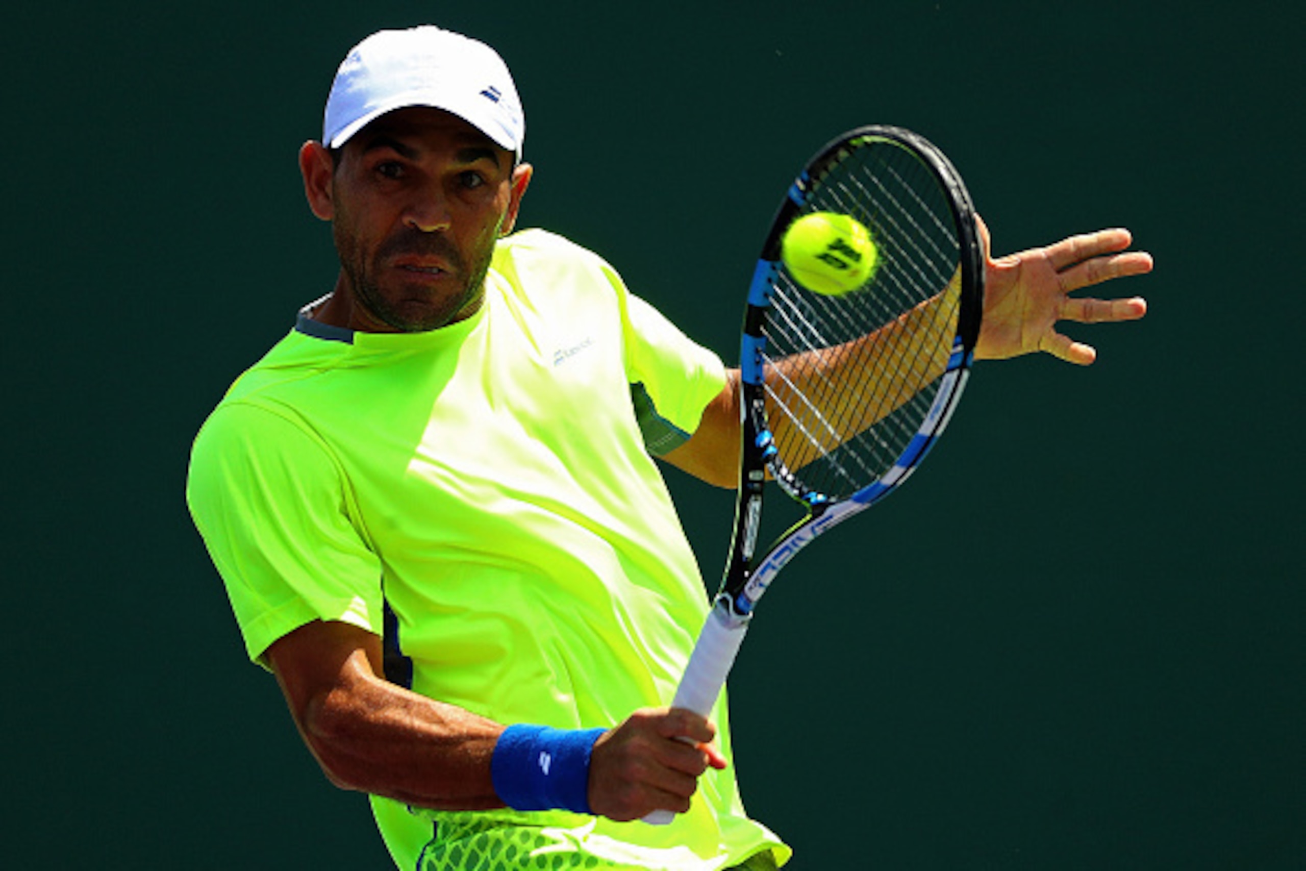 KEY BISCAYNE, FL - MARCH 23: Victor Estrella Burgos of the Dominican Republic plays a match against Sam Groth of Australia during Day 3 of the Miami Open presented by Itau at Crandon Park Tennis Center on March 23, 2016 in Key Biscayne, Florida. (Photo KEY BISCAYNE, FL - MARCH 23: Victor Estrella Burgos of the Dominican Republic plays a match against Sam Groth of Australia during Day 3 of the Miami Open presented by Itau at Crandon Park Tennis Center on March 23, 2016 in Key Biscayne, Florida. (Photo