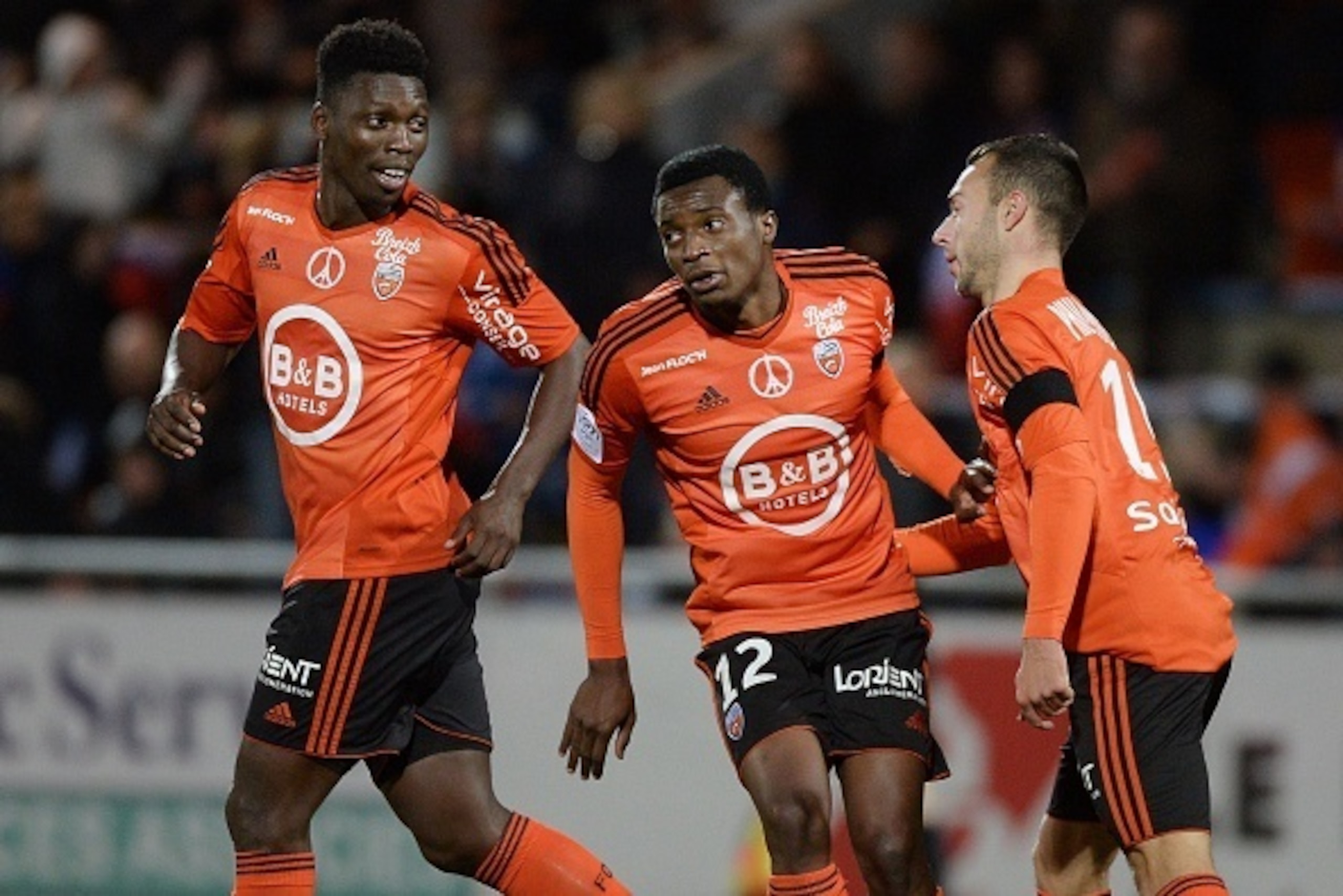 Lorient's Cameroonian forward Benjamin Moukandjo (C) celebrates with his teammate Lorient's French midfielder Romain Philippoteaux (R) after scoring a goal during the French L1 football match between Lorient and Paris Saint-Germain on November 21, 2015 at