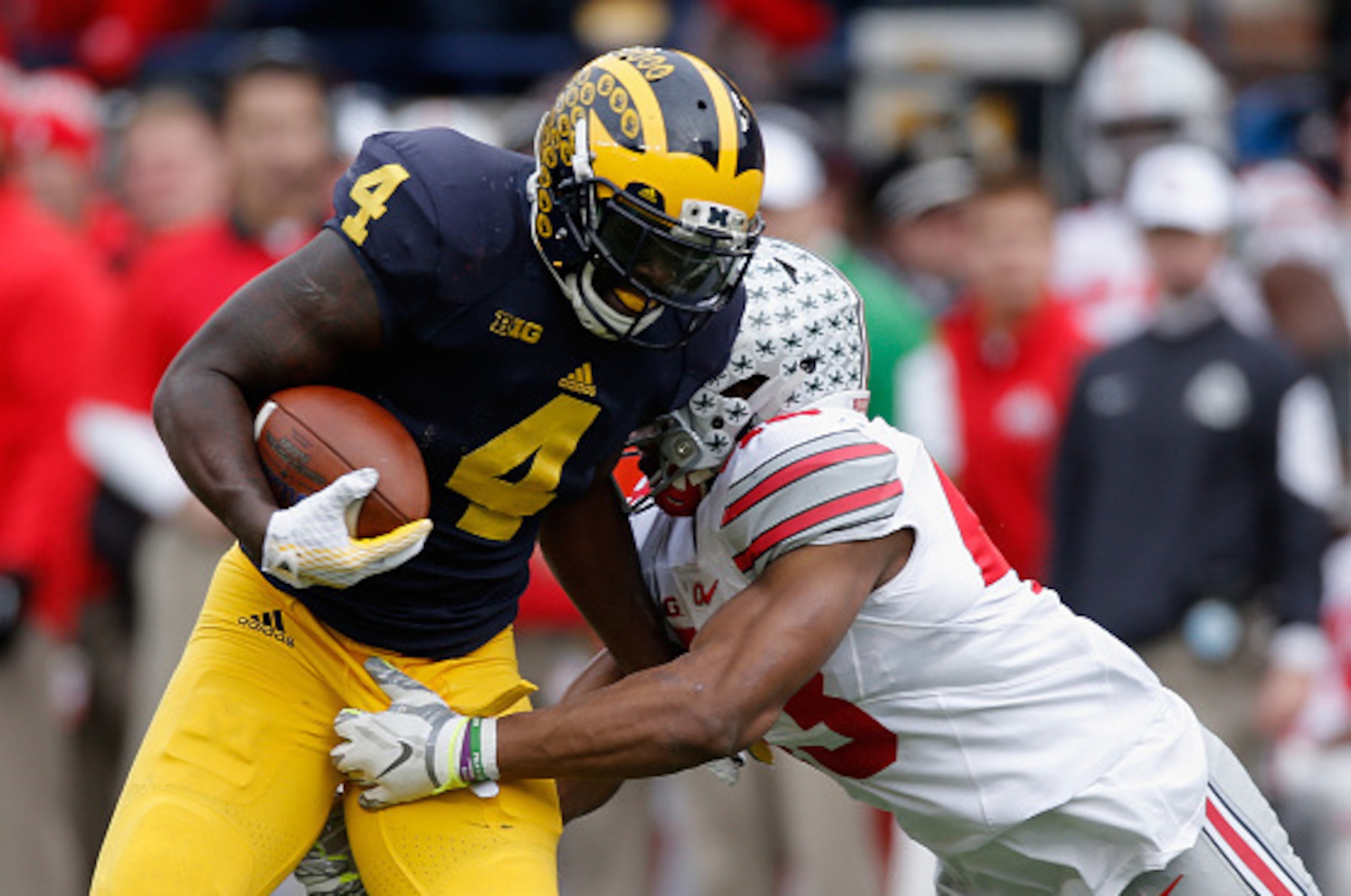 ANN ARBOR, MI - NOVEMBER 28: De'Veon Smith #4 of the Michigan Wolverines is tackled by Darron Lee #43 of the Ohio State Buckeyes in the first half at Michigan Stadium on November 28, 2015 in Ann Arbor, Michigan.  (Photo by Gregory Shamus/Getty Images)