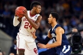 Apr 2, 2016; Houston, TX, USA; Oklahoma Sooners guard Buddy Hield (24) handles the ball against Villanova Wildcats guard Josh Hart (3) during the first half in the 2016 NCAA Men's Division I Championship semi-final game at NRG Stadium. Mandatory Credit: B