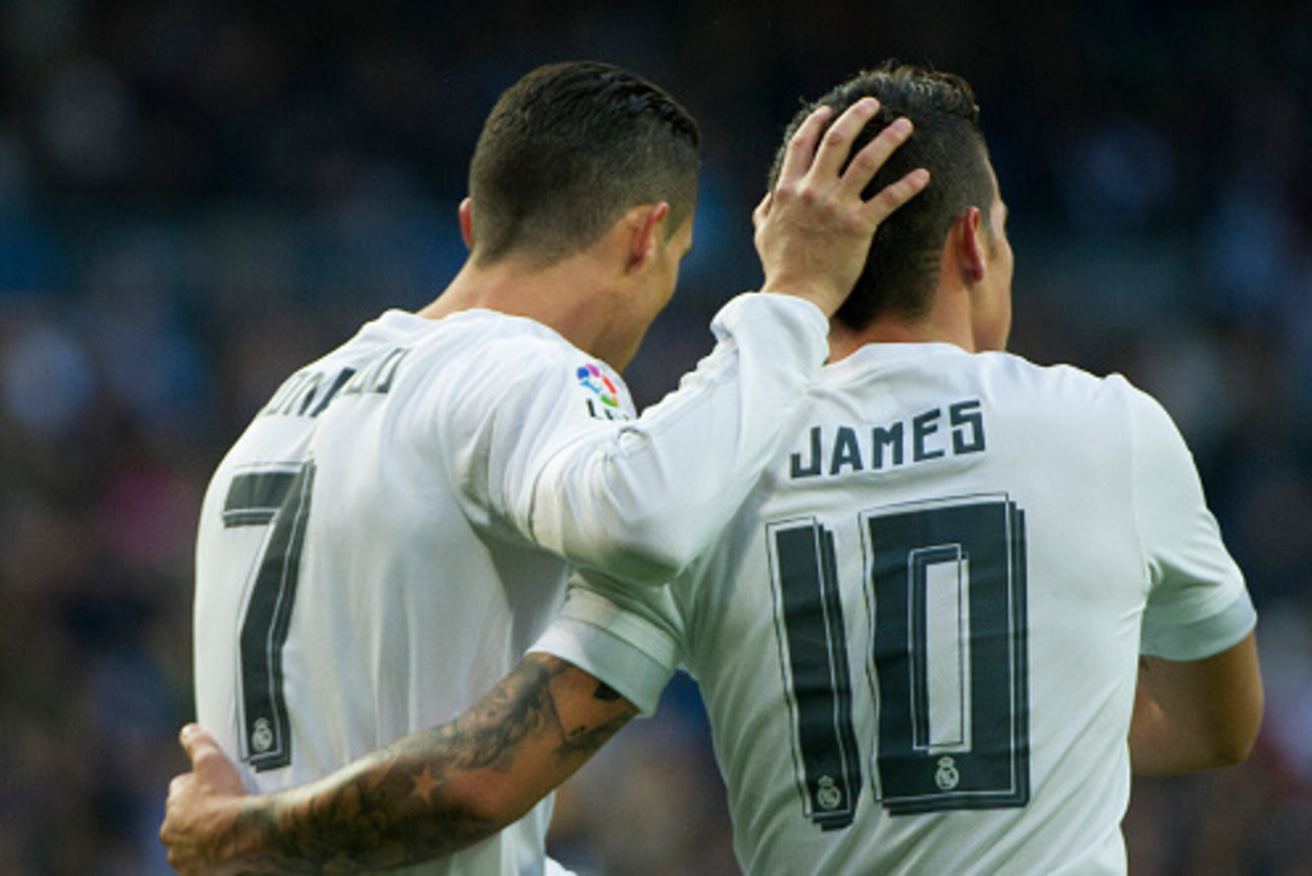 Real Madrid's Portuguese forward Cristiano Ronaldo (L) celebrates after scoring with teammate Real Madrid's Colombian midfielder James Rodriguez during the Spanish league football match Real Madrid CF vs Rayo Vallecano de Madrid at the Santiago Bernabeu s