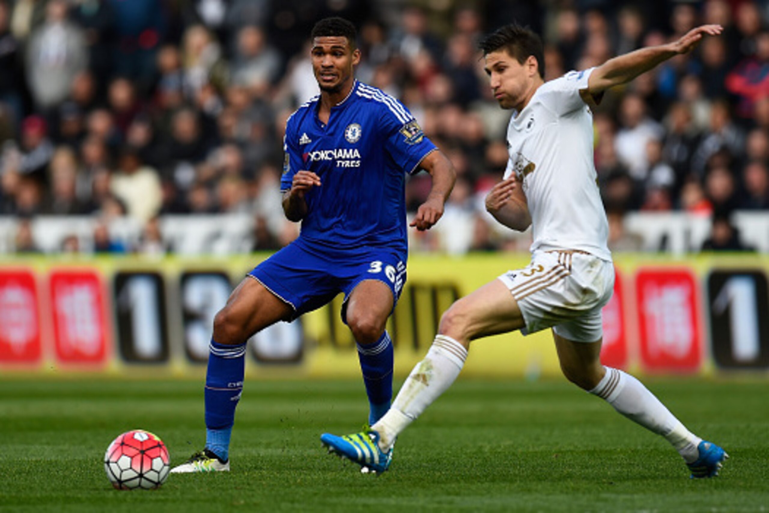 SWANSEA, UNITED KINGDOM - APRIL 09: Ruben Loftus-Cheek of Chelsea and Federico Fernandez of Swansea City compete for the ball during the Barclays Premier League match between Swansea City and Chelsea at the Liberty Stadium on April 9, 2016 in Swansea, Wal