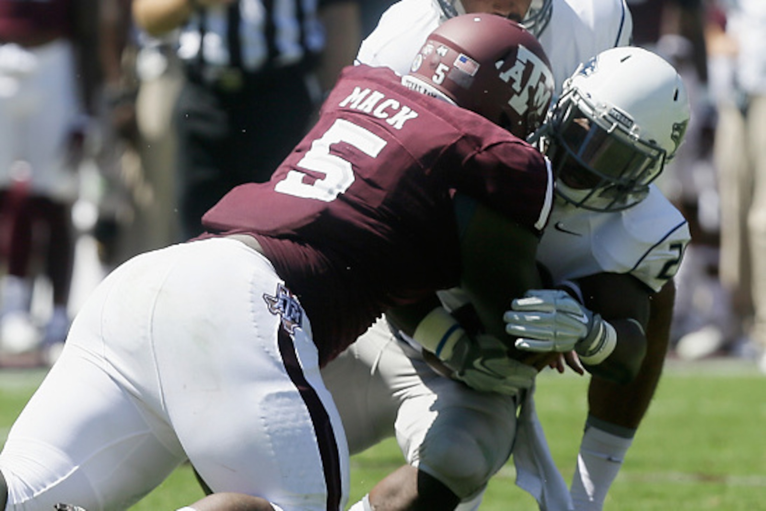 COLLEGE STATION, TX - SEPTEMBER 19: Dominic Christian #2 of the Nevada Wolf Pack is leveled by Daylon Mack #5 of the Texas A&M Aggies as he takes the handoff from Tyler Stewart #15 at Kyle Field on September 19, 2015 in College Station, Texas. (Photo by COLLEGE STATION, TX - SEPTEMBER 19: Dominic Christian #2 of the Nevada Wolf Pack is leveled by Daylon Mack #5 of the Texas A&M Aggies as he takes the handoff from Tyler Stewart #15 at Kyle Field on September 19, 2015 in College Station, Texas. (Photo by