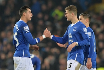 Everton's English defender John Stones (R) shakes hands with Everton's Argentinian defender Ramiro Funes Mori (L) after the final whistle of the English League Cup semi-final first leg football match between Everton and Manchester City at Goodison Park in