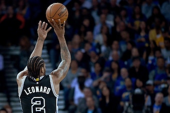OAKLAND, CALIFORNIA - APRIL 07:  Kawhi Leonard #2 of the San Antonio Spurs shoots against the Golden State Warriors during an NBA Basketball game at ORACLE Arena on April 7, 2016 in Oakland, California. NOTE TO USER: User expressly acknowledges and agrees