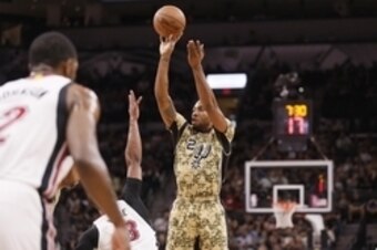 Mar 23, 2016; San Antonio, TX, USA; San Antonio Spurs small forward Kawhi Leonard (2) shoots the ball over Miami Heat shooting guard Dwyane Wade (3) during the first half at AT&T Center. Mandatory Credit: Soobum Im-USA TODAY Sports
