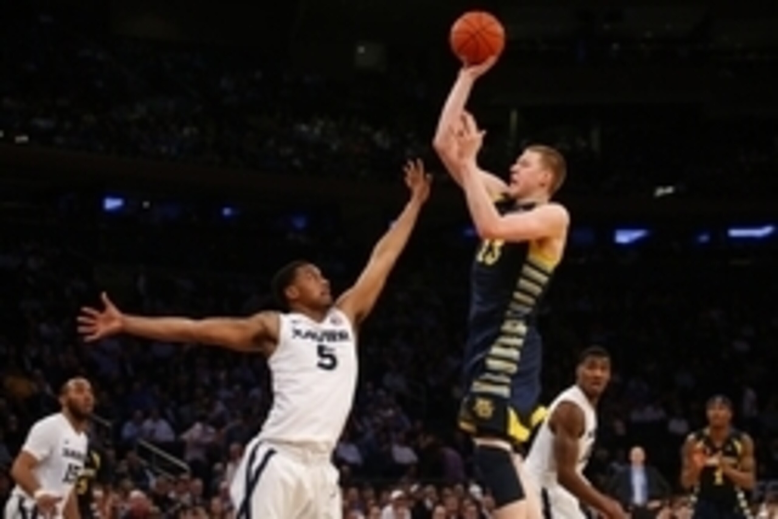 Mar 10, 2016; New York, NY, USA; Xavier Musketeers guard Trevon Bluiett (5) defends against Marquette Golden Eagles forward Henry Ellenson (13) during the second half of the Big East conference tournament at Madison Square Garden. Xavier Musketeers defeat