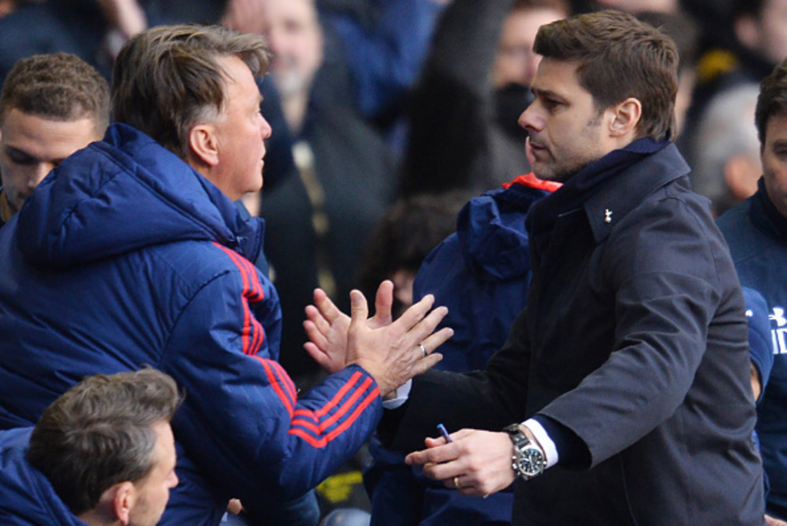 Tottenham Hotspur's Argentinian head coach Mauricio Pochettino (R) shakes hands with Manchester United's Dutch manager Louis van Gaal after the English Premier League football match between Tottenham Hotspur and Manchester United at White Hart Lane in Lon