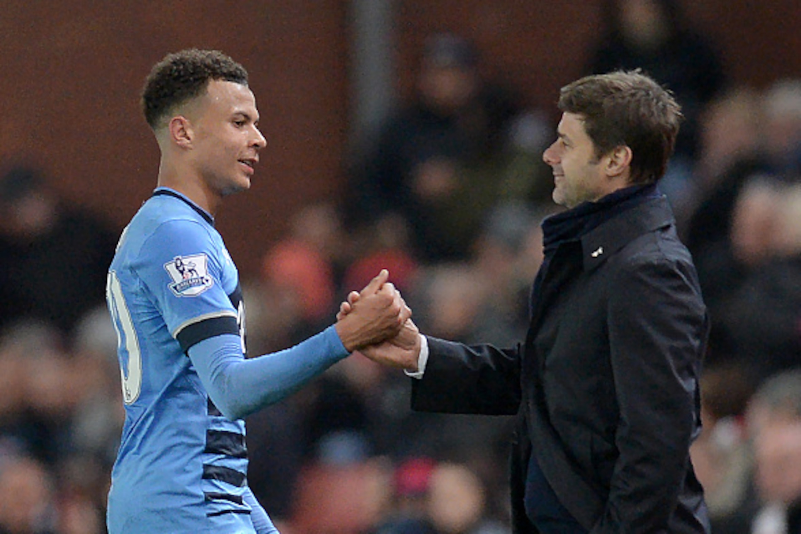 Tottenham Hotspur's English midfielder Dele Alli (L) speaks with Tottenham Hotspur's Argentinian head coach Mauricio Pochettino as he is substituted during the English Premier League football match between Stoke City and Tottenham Hotspur at the Britannia