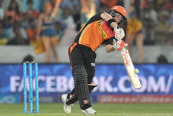 Sunrisers Hyderabad captain David Warner plays a shot during the 2016 Indian Premier League (IPL) Twenty20 cricket match between Sunrisers Hyderabad and Mumbai Indians at The Rajiv Gandhi International Stadium in Hyderabad on April 18, 2016. / AFP / Noah 