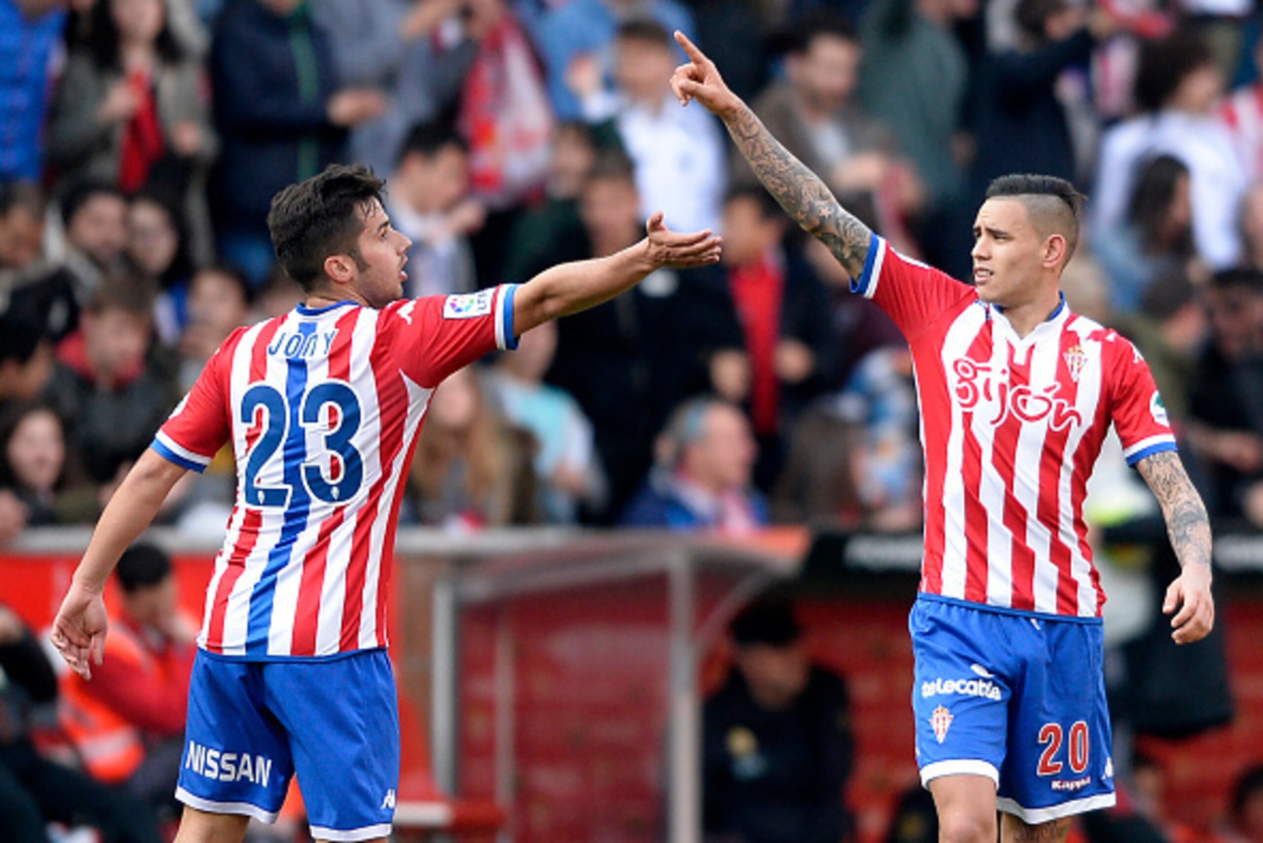 Sporting Gijon's Paraguayan forward Sanabria (R) celebrates after scoring a goal next to teammate Sporting Gijon's midfielder Jony during the Spanish league football match Real Sporting de Gijon vs Club Atletico de Madrid at El Molinon stadium in Gijon on