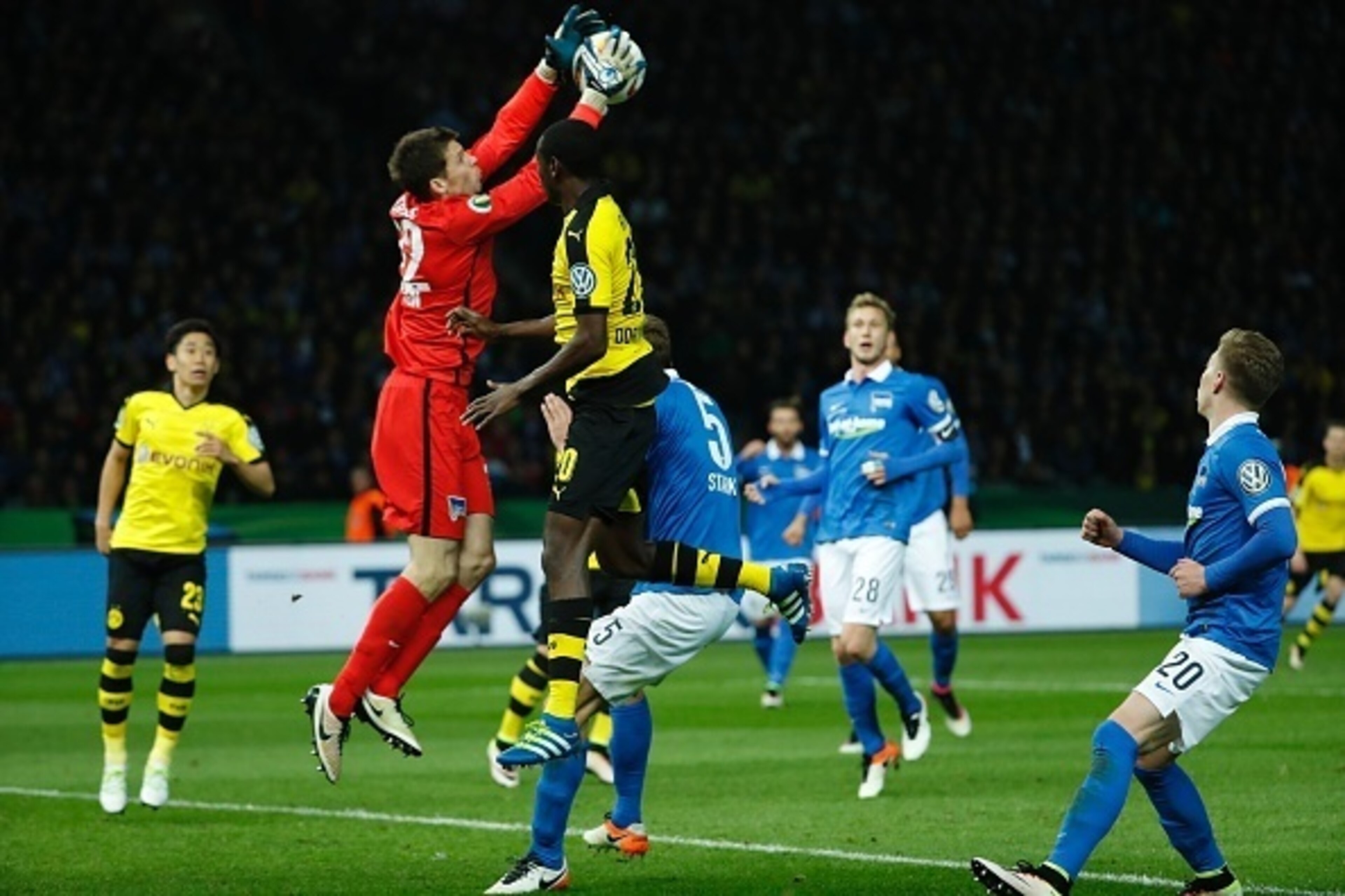 Hertha's Norwegian goalkeeper Rune Jarstein gets to the ball before Dortmund's Columbian striker Adrian Ramos (C) during the German Cup (DFB Pokal) semi-final football match Hertha Berlin v Borussia Dortmund at the Olympic stadium in Berlin on April 20, 2