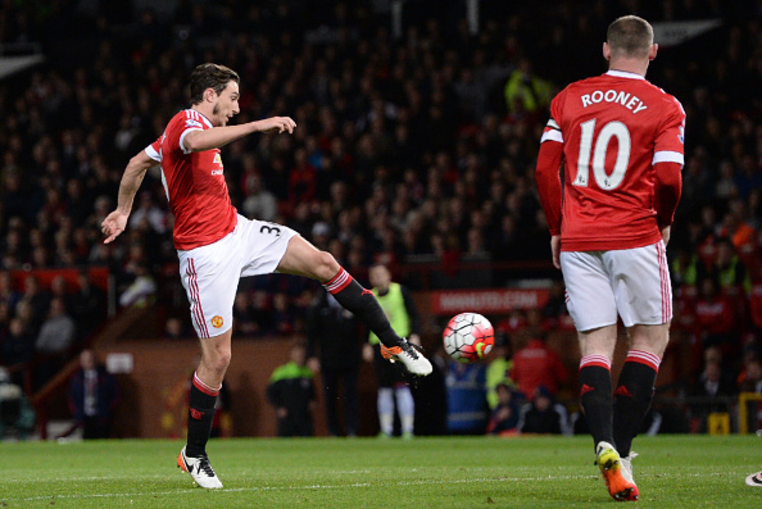 Manchester United's Italian defender Matteo Darmian (L) shoots and scores during the English Premier League football match between Manchester United and Crystal Palace at Old Trafford in Manchester, north west England, on April 20, 2016. / AFP / OLI SCARF