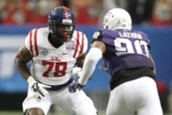 Dec 31, 2014; Atlanta , GA, USA; Mississippi Rebels offensive lineman Laremy Tunsil (78) prepares to block TCU Horned Frogs defensive tackle Terrell Lathan (90) during the first quarter in the 2014 Peach Bowl at the Georgia Dome. Mandatory Credit: Brett D