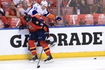 Apr 14, 2016; Sunrise, FL, USA; Florida Panthers defenseman Alex Petrovic (6) checks New York Islanders center Casey Cizikas (53) in the first period on the first round of the 2016 Stanley Cup Playoffs at BB&T Center. Mandatory Credit: Robert Mayer-USA TO