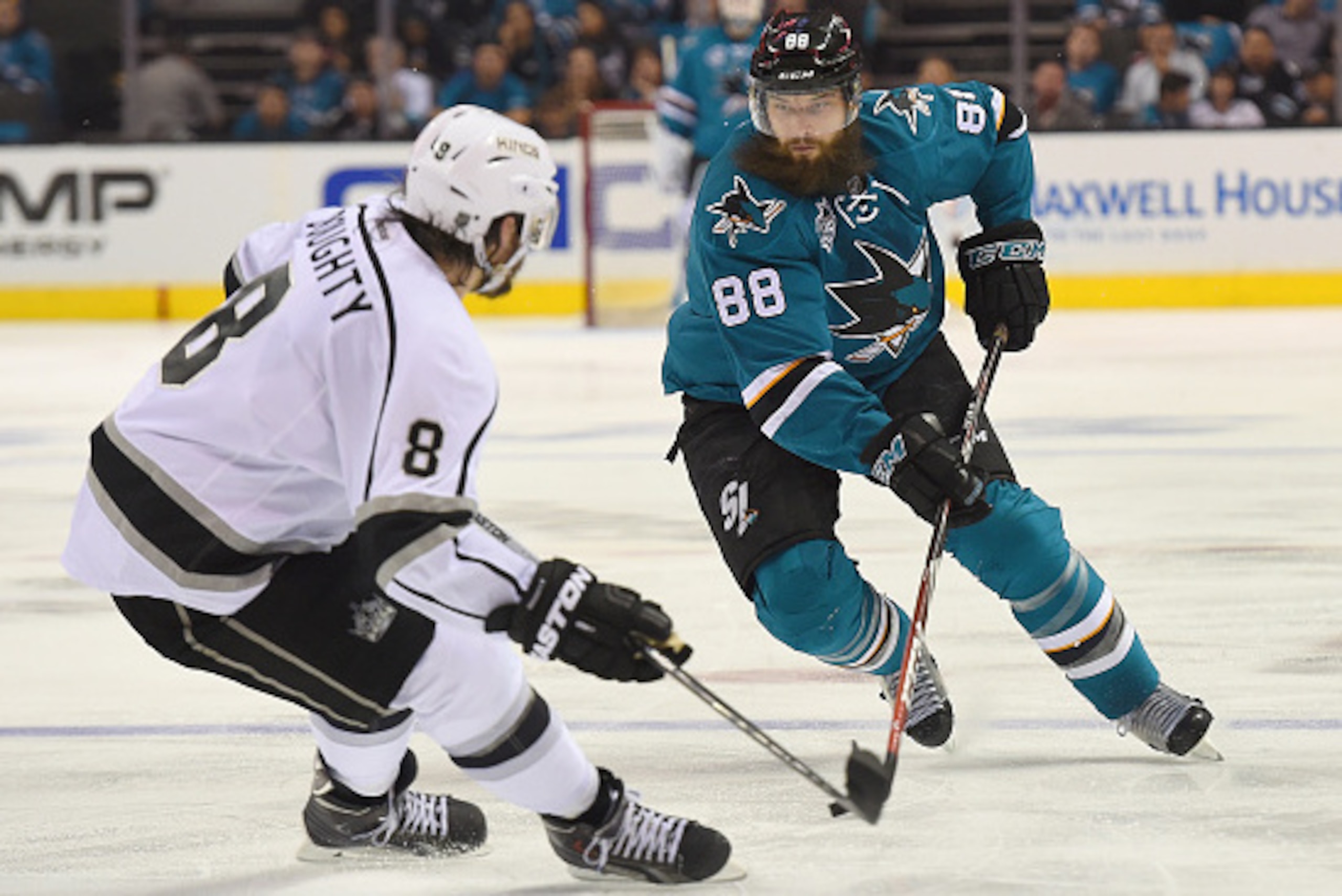 SAN JOSE, CA - APRIL 18:  Brent Burns #88 of the San Jose Sharks controling the puck, looks to skate past Drew Doughty #8 of the Los Angeles Kings in the second period in Game Three of the Western Conference Quarterfinals during the 2016 NHL Stanley Cup P