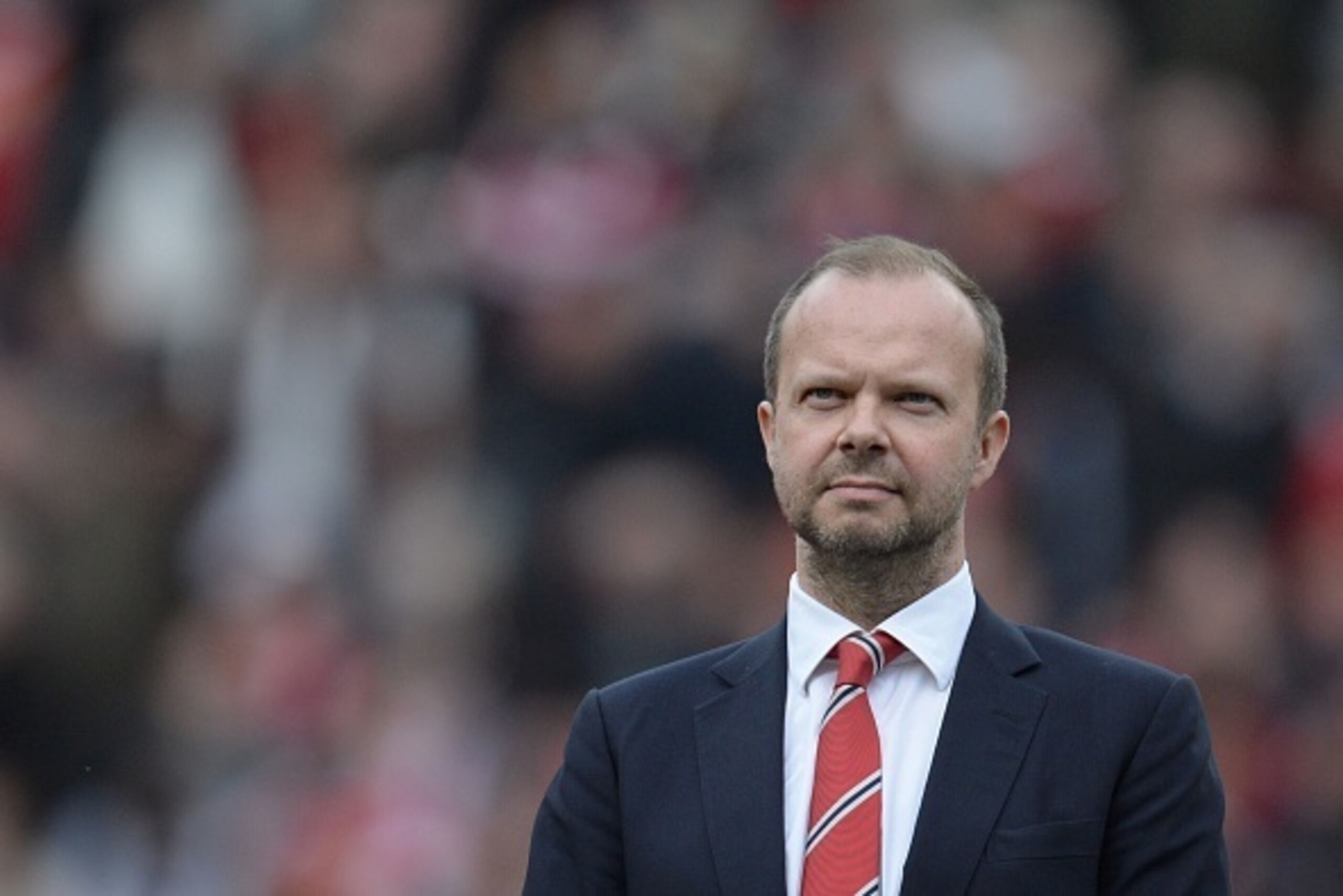 Manchester United's executive vice-chairman Ed Woodward stands on the pitch before the start of the English Premier League football match between Manchester United and Everton at Old Trafford in Manchester, north west England, on April 3, 2016. / AFP / OL