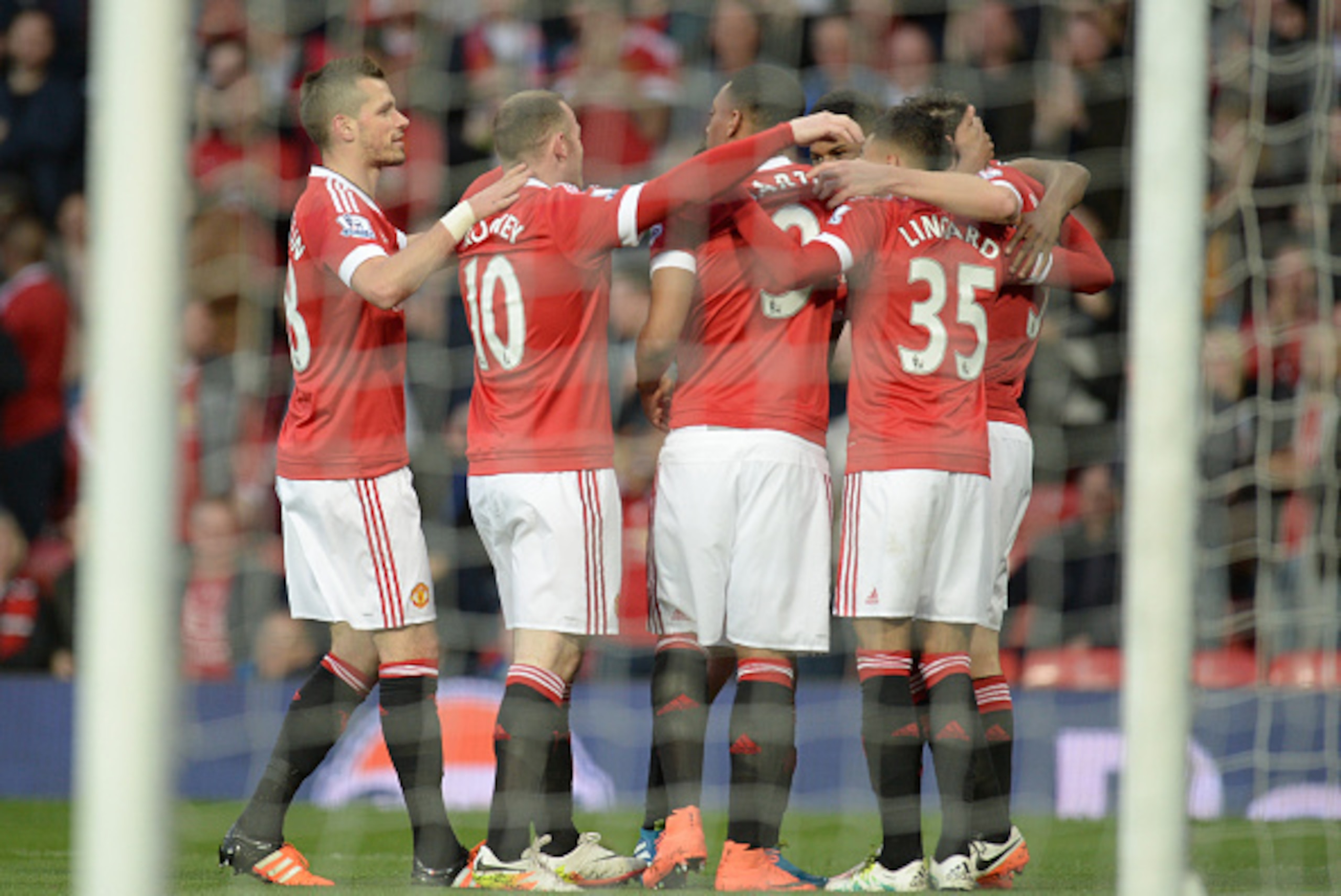 Manchester United players celebrate after Palace scored an own goal during the English Premier League football match between Manchester United and Crystal Palace at Old Trafford in Manchester, north west England, on April 20, 2016. / AFP / OLI SCARFF / RE