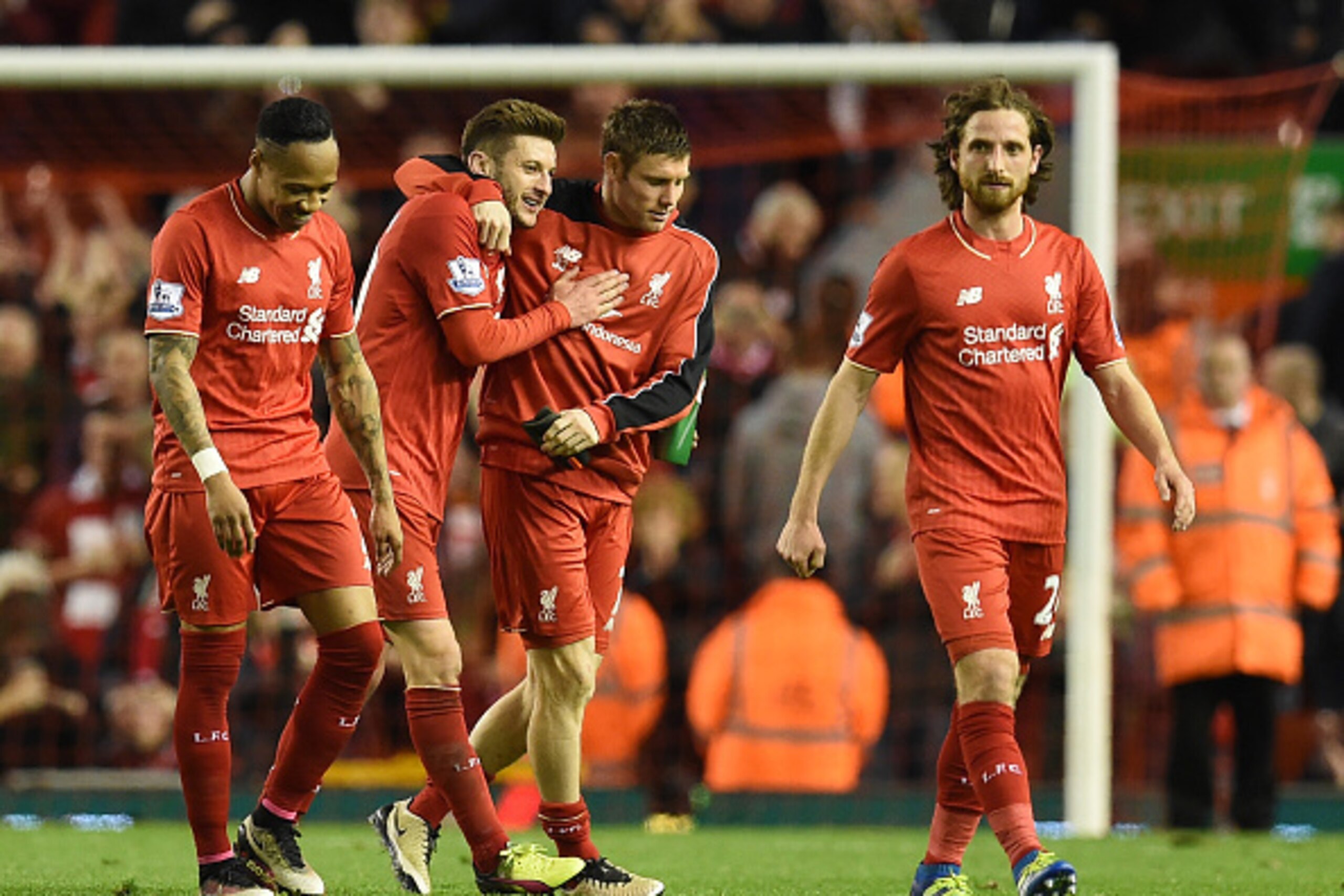 Liverpool's English midfielder Adam Lallana (2L) celebrates with Liverpool's English midfielder James Milner after winning the English Premier League football match between Liverpool and Everton at Anfield in Liverpool, north west England on April 20, 201