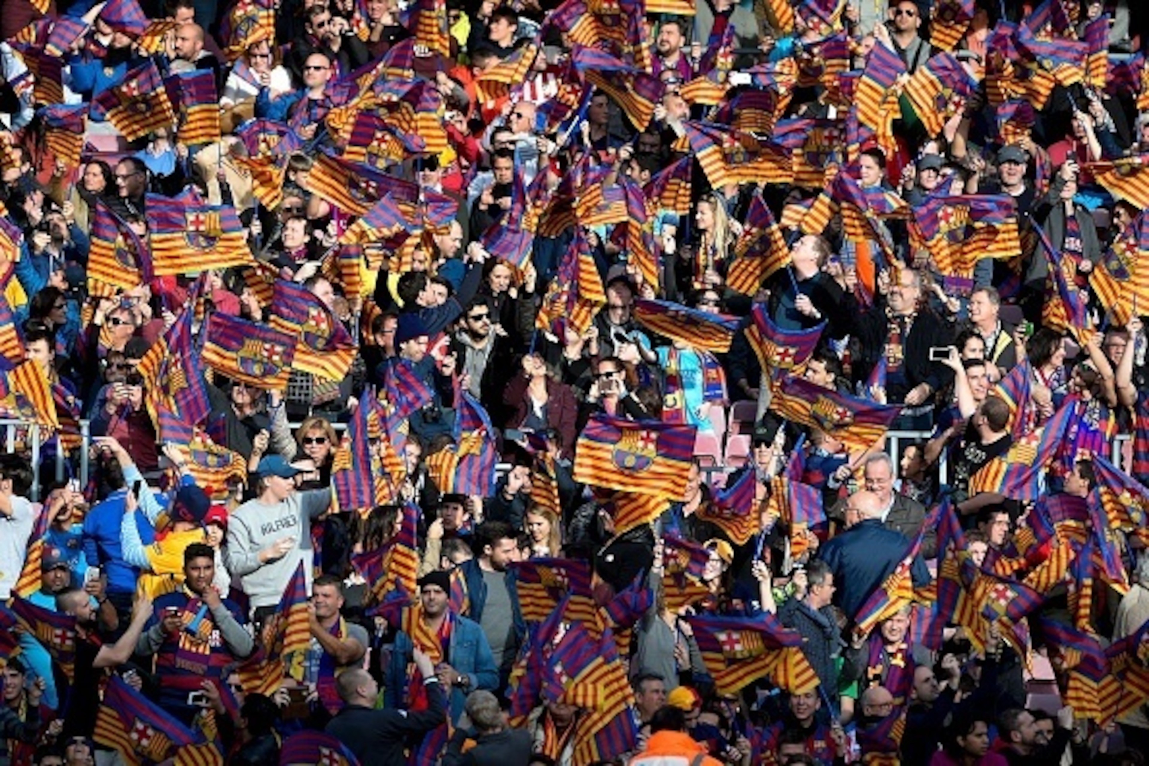 Barcelona supporters wave flags during the Spanish league football match FC Barcelona vs Club Atletico de Madrid at the Camp Nou stadium in Barcelona on January 30, 2016. Barcelona won 2-1. AFP PHOTO/ JOSEP LAGO / AFP / JOSEP LAGO (Photo credit s Barcelona supporters wave flags during the Spanish league football match FC Barcelona vs Club Atletico de Madrid at the Camp Nou stadium in Barcelona on January 30, 2016. Barcelona won 2-1. AFP PHOTO/ JOSEP LAGO / AFP / JOSEP LAGO (Photo credit s