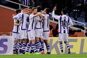 Real Sociedad players celebrate after scoring during the Spanish league football match Real Sociedad vs FC Barcelona at the Anoeta stadium in San Sebastian on April 9, 2016. / AFP / ANDER GILLENEA        (Photo credit should read ANDER GILLENEA/AFP/Getty 