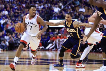 TORONTO, ON - APRIL 18:  Kyle Lowry #7 of the Toronto Raptors dribbles the ball past George Hill #3 of the Indiana Pacers in the second half of Game Two of the Eastern Conference Quarterfinals during the 2016 NBA Playoffs at the Air Canada Centre on April